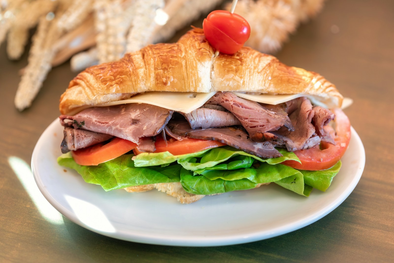 Shredded beef French dip sandwich with a cup of jus