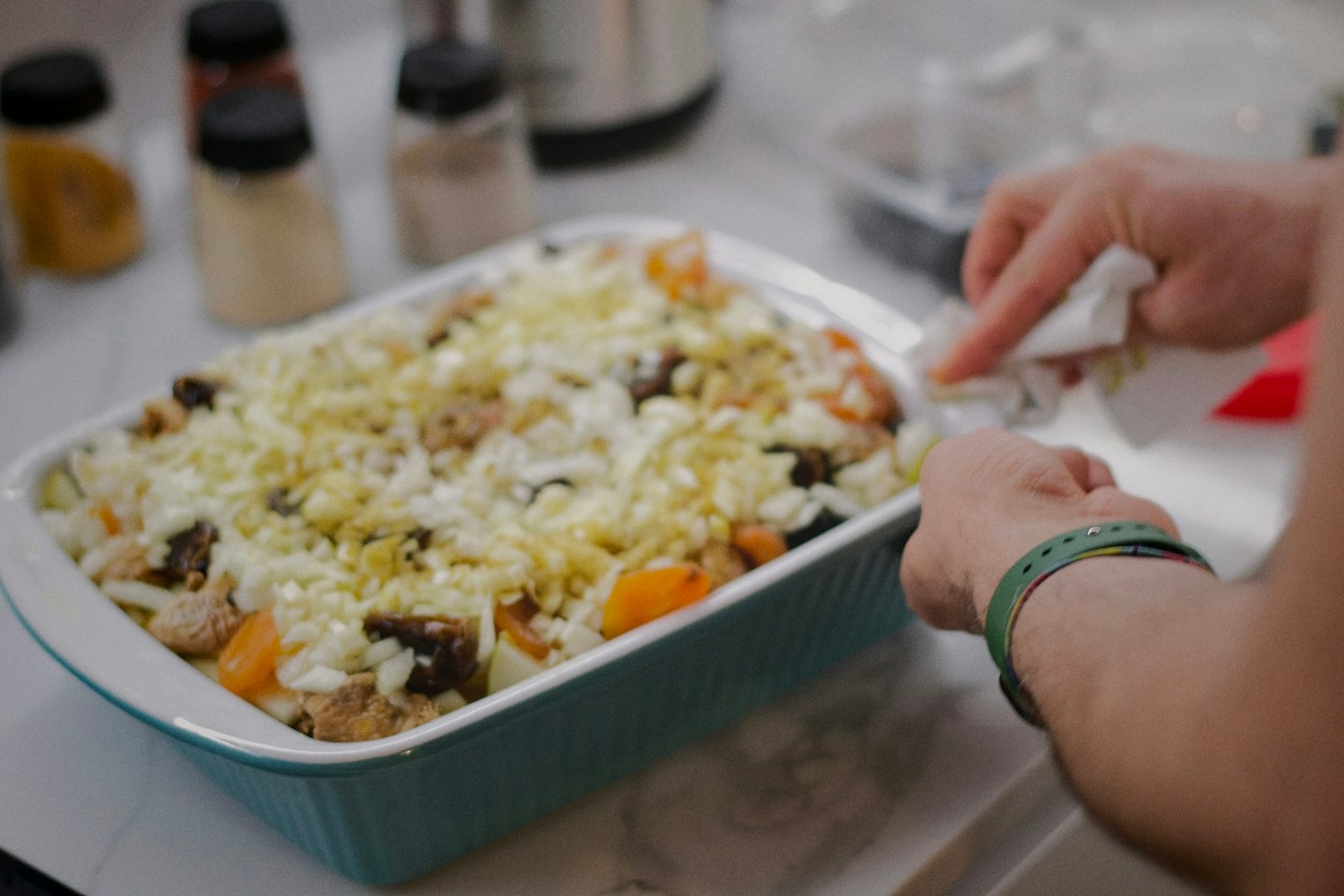 Ham and potato casserole topped with cheese before baking