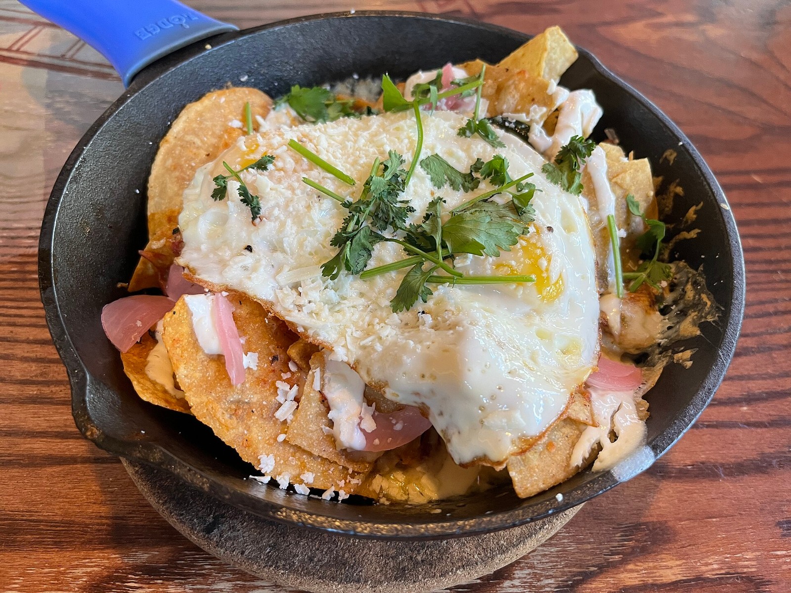 Chilaquiles skillet bake with fried egg, salsa and crumbled cheese