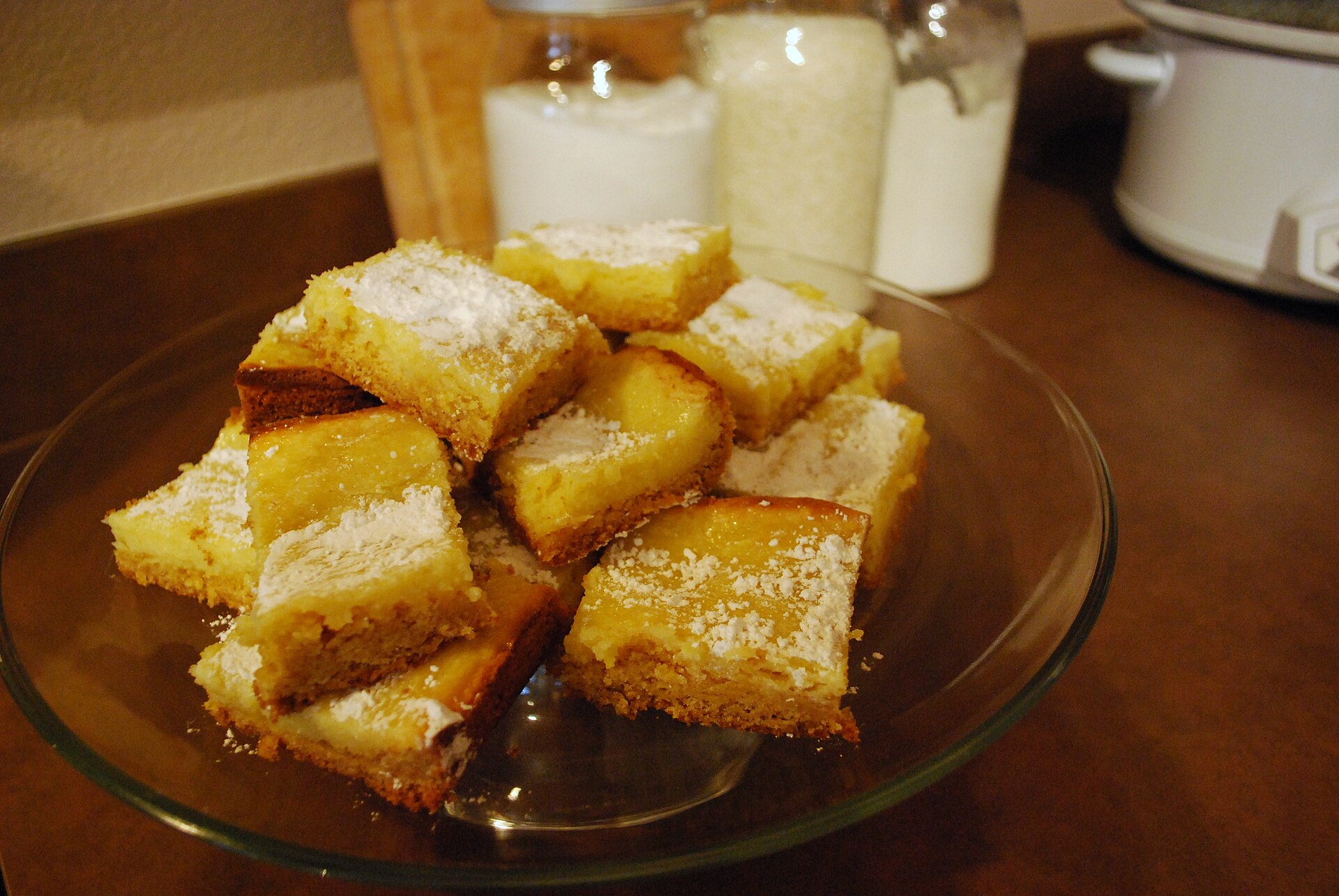 Squares of St. Louis gooey butter cake, one of the funny named desserts, on a glass plate
