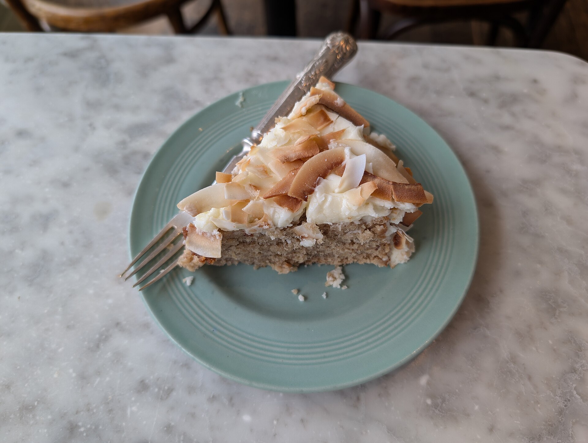 A slice of hummingbird cake, one of the most famous funny named desserts, on a green plate