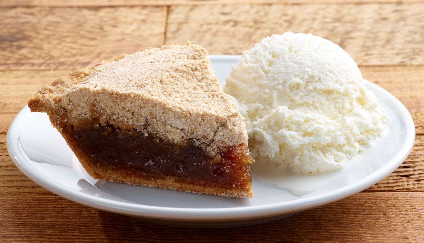 Slice of Pennsylvania Dutch shoofly pie with vanilla ice cream