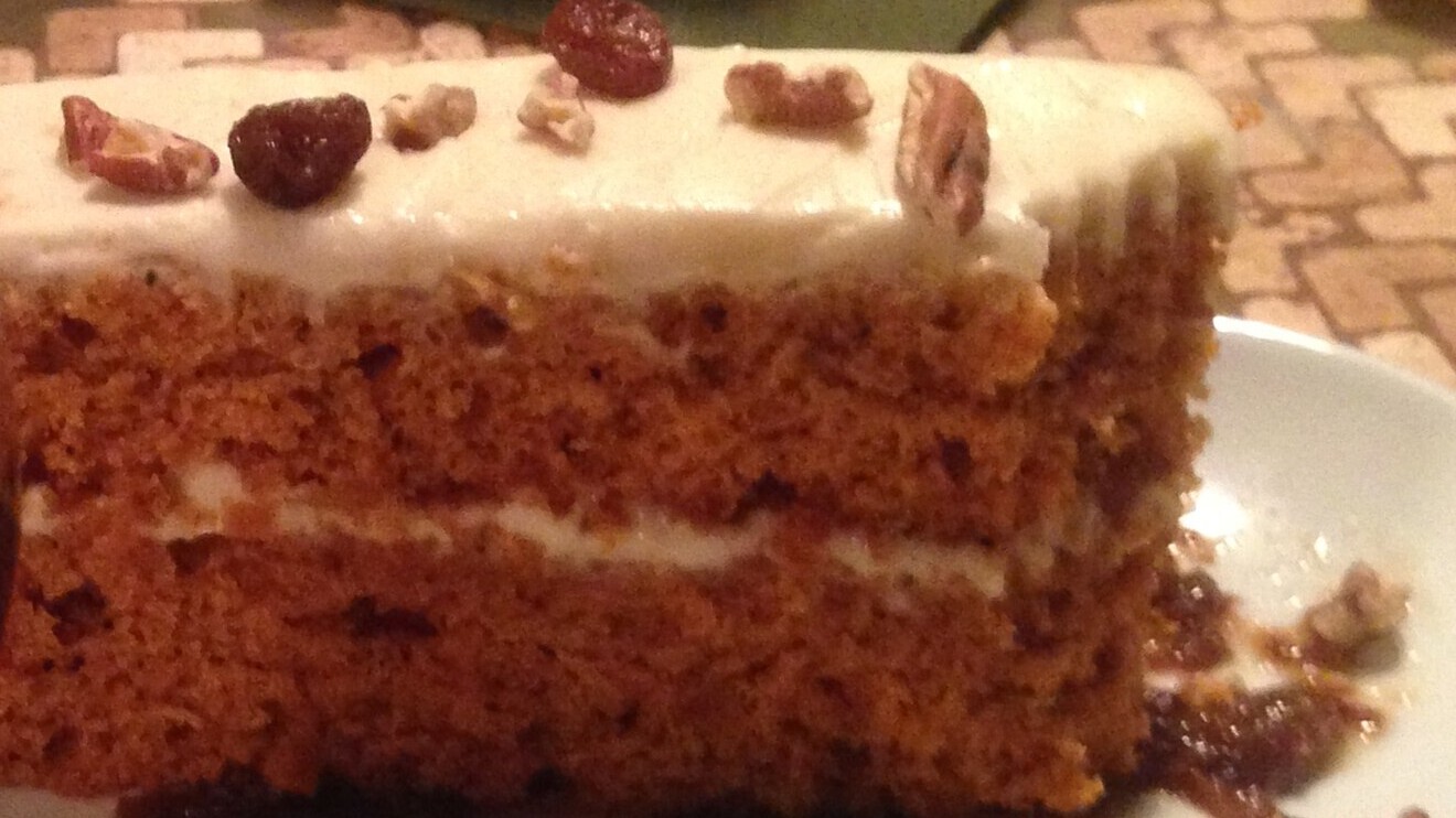 Slice of tomato soup cake with cream cheese frosting, an old mystery cake recipe