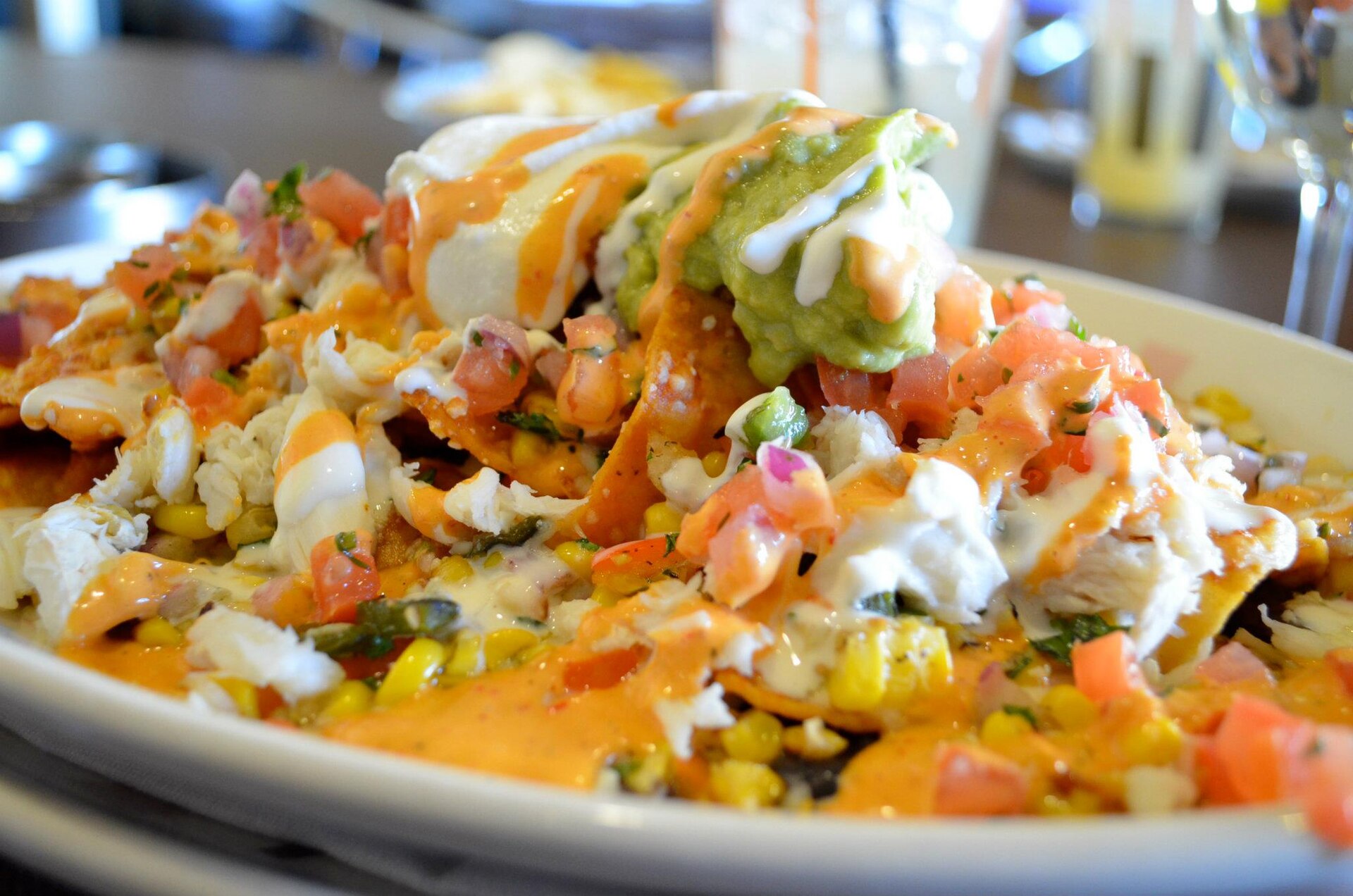 Loaded nachos with corn, pico de gallo and a creamy sauce