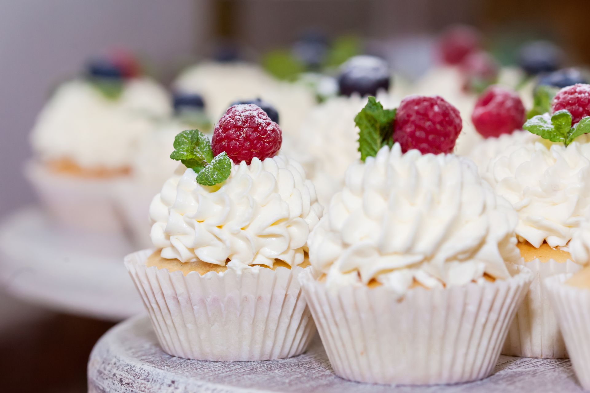 Cupcakes with whipped cream and raspberries