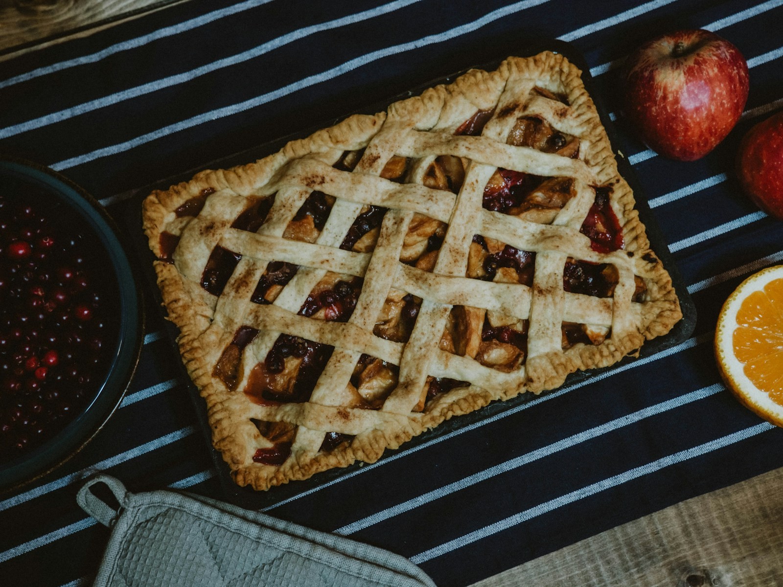 Apple slab pie with a woven lattice crust on a dark tray