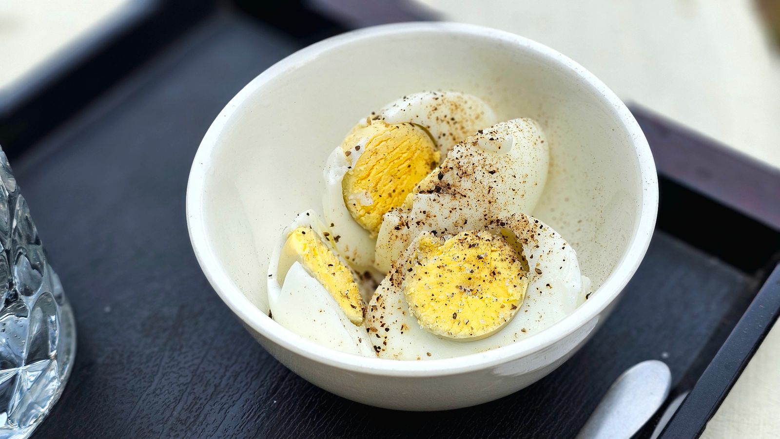 Halved hard cooked eggs in a white bowl