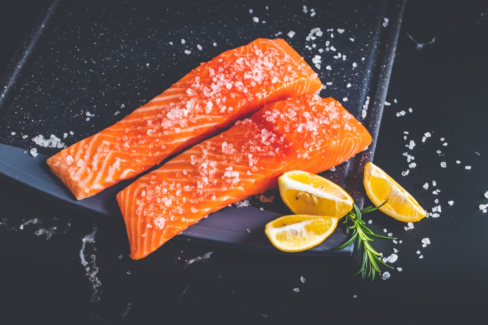Salmon fillets with lemon slices ready to cook