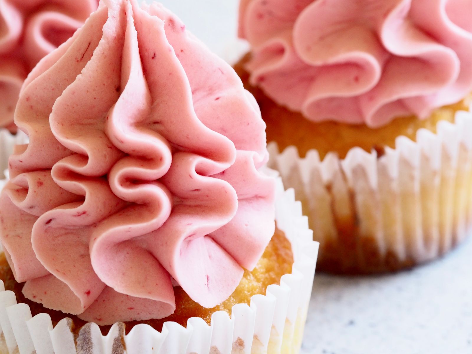 Frosting recipes: cupcakes with tall pink swirls of meringue buttercream