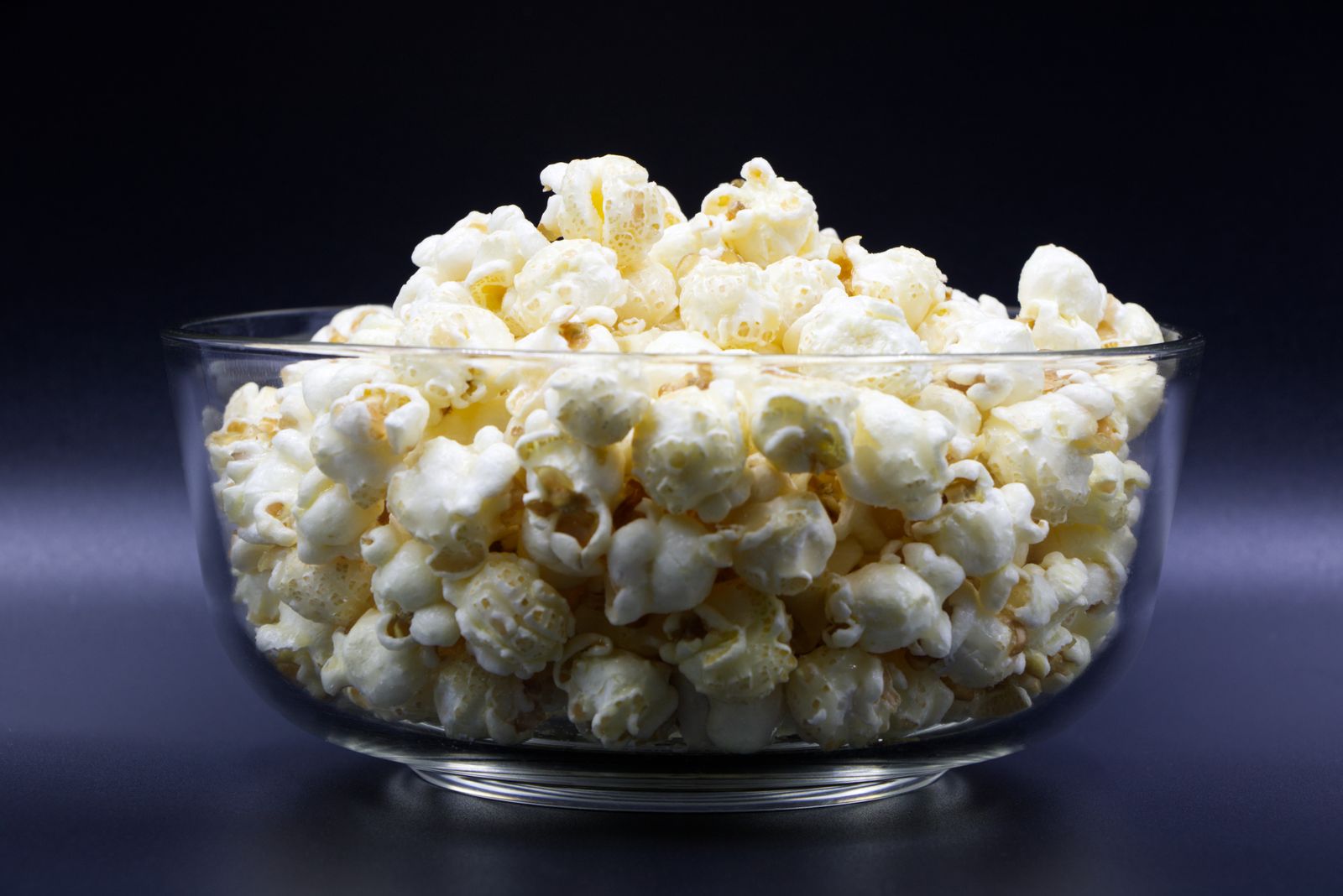 Glass bowl filled with fresh popcorn