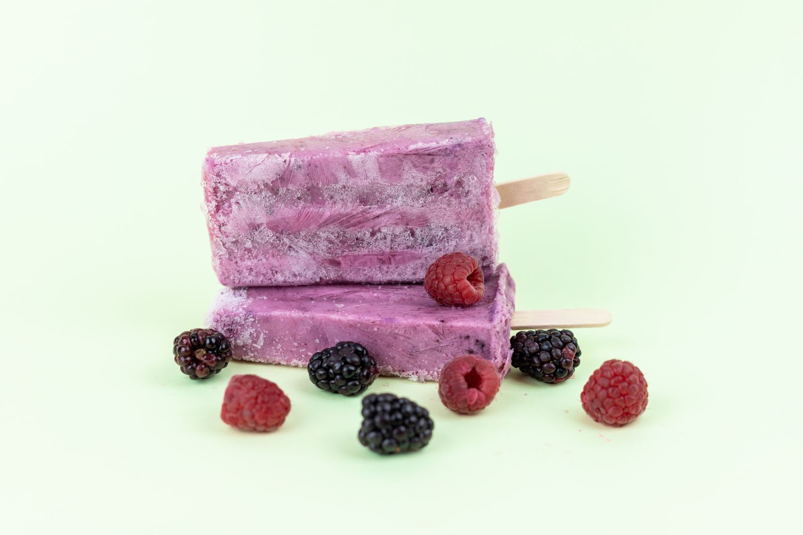 Team snacks for kids: berry yogurt popsicles on a white table