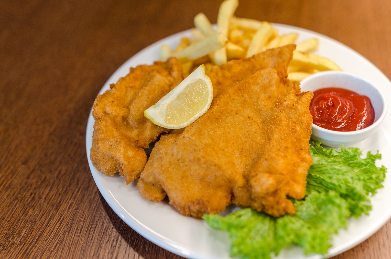 Crispy golden fillet with fries and lemon