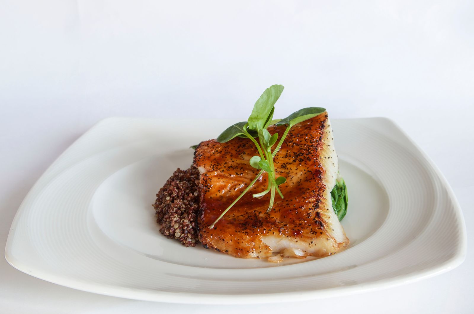 Seared honey glazed cod on a plate