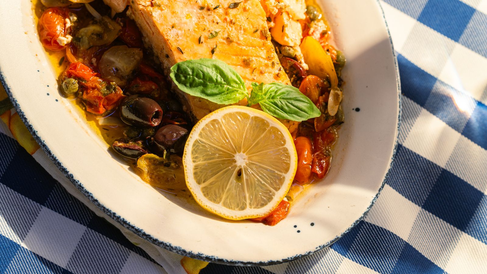 Baked cod with tomatoes, olives and lemon