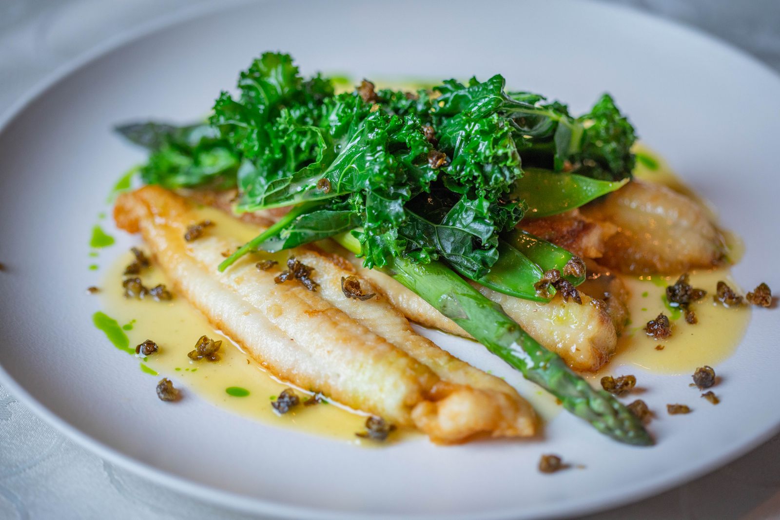 White fish recipes: fish fillet with lemon butter caper sauce and greens