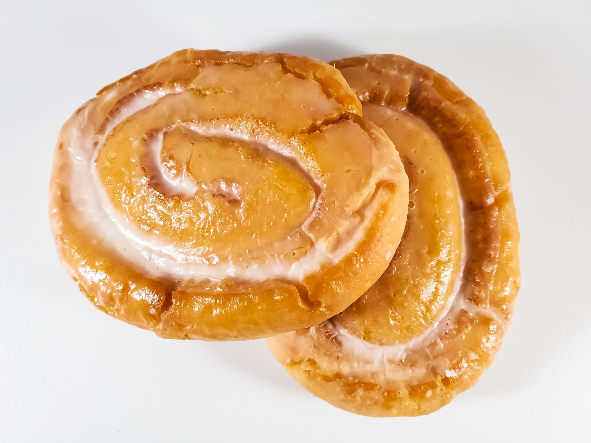 Flat glazed spiral treats on a white background