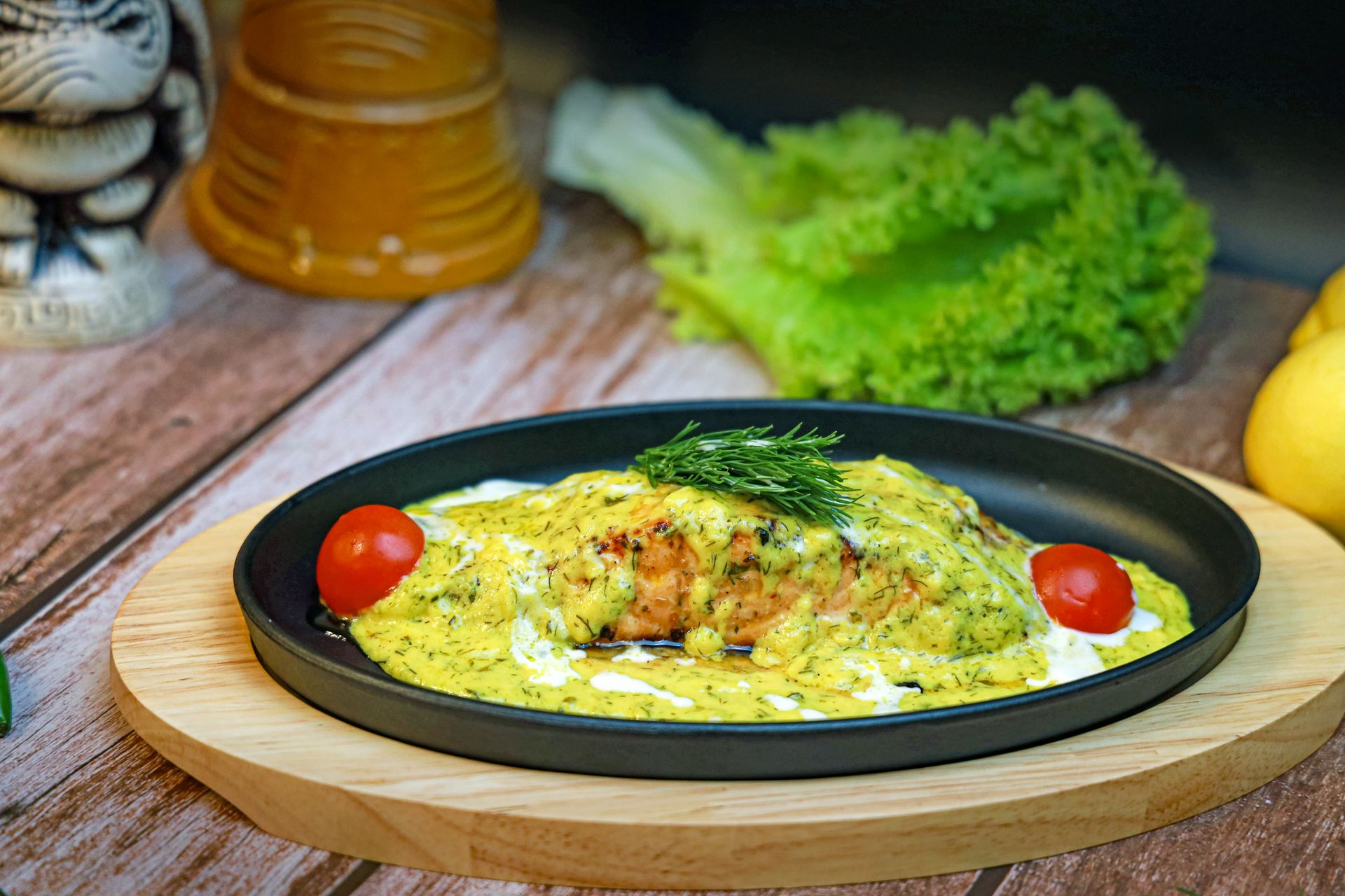 Baked fish under a bubbling cheese sauce with cherry tomatoes