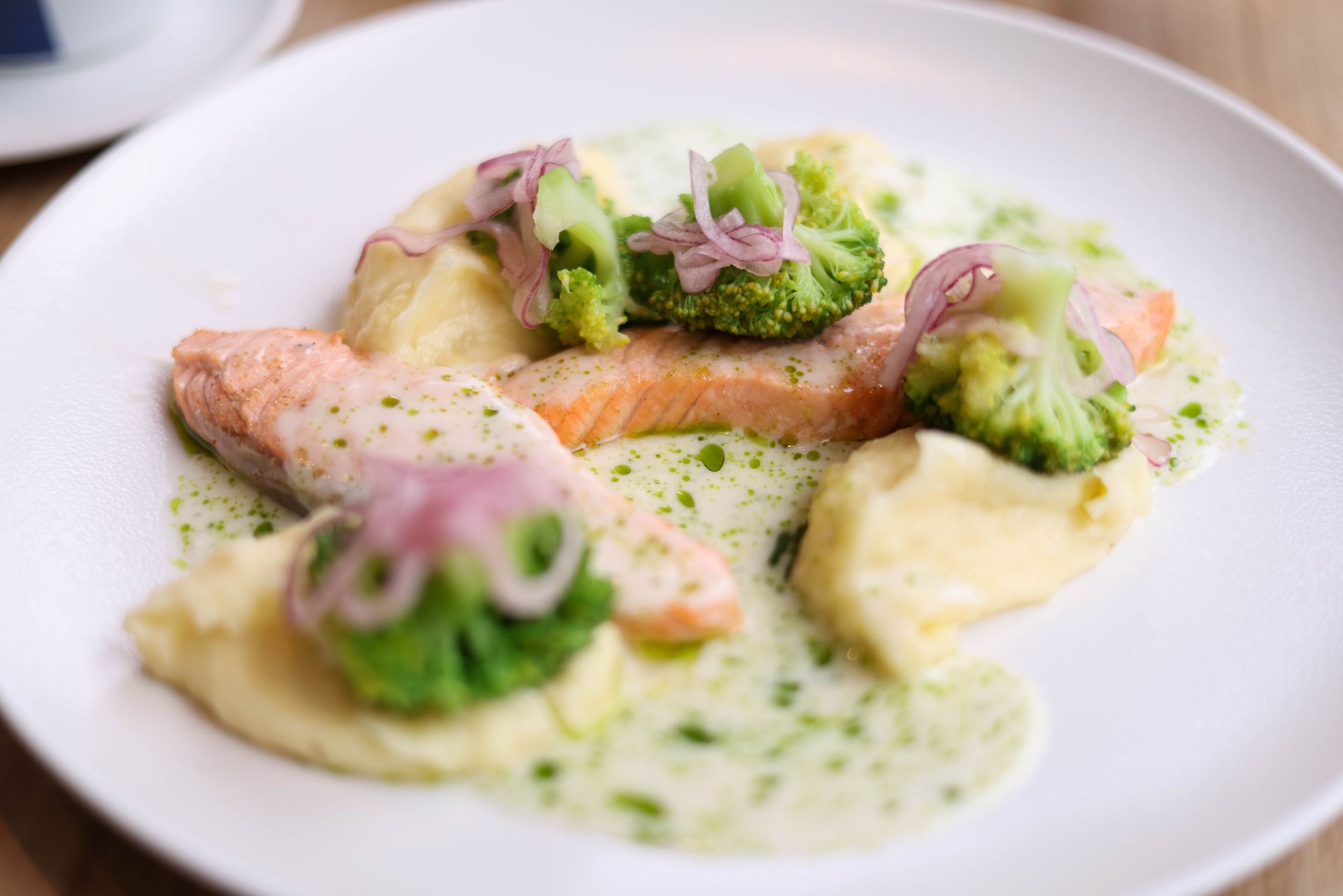 Creamy salmon with broccoli in a green herb cream sauce