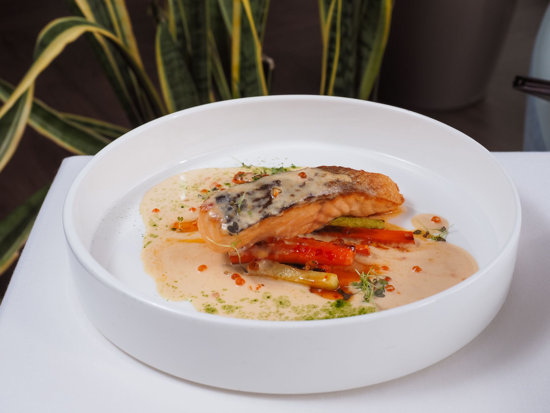 Seared fish over a spicy orange Cajun cream sauce with peppers