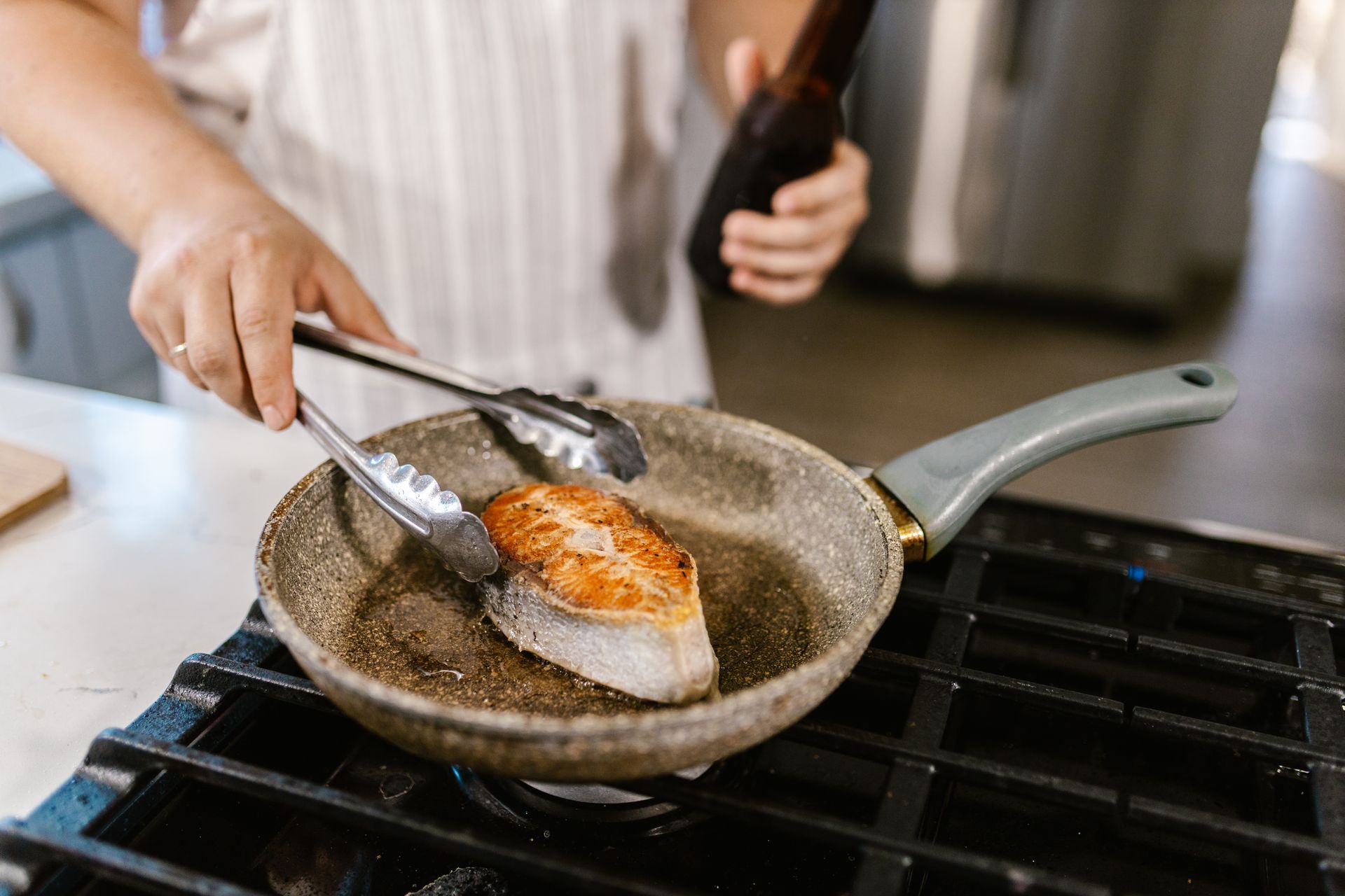 Creamy salmon starts here: a fillet searing in a hot pan