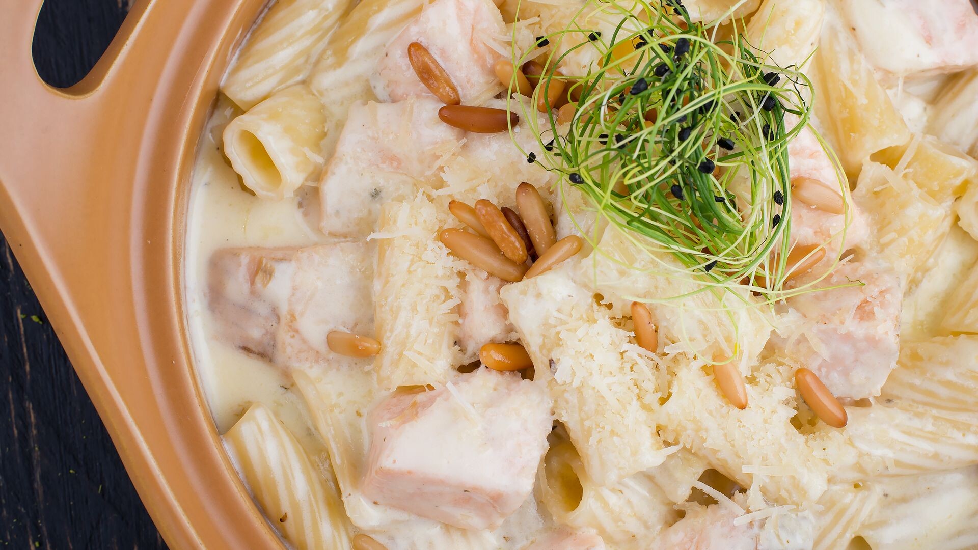 Creamy salmon penne with a parmesan cream sauce and fresh greens