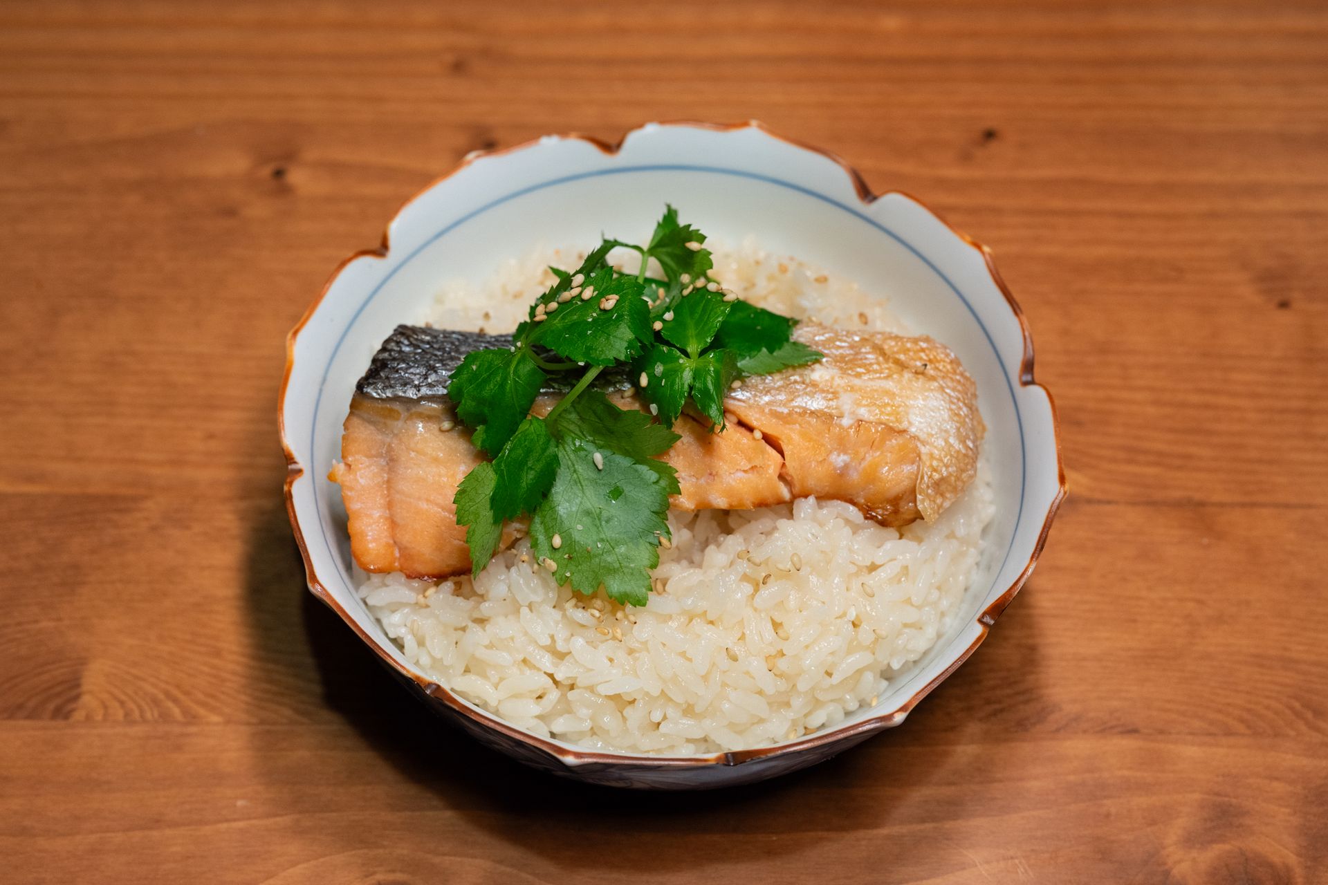 Fish and rice bowl topped with fresh cilantro