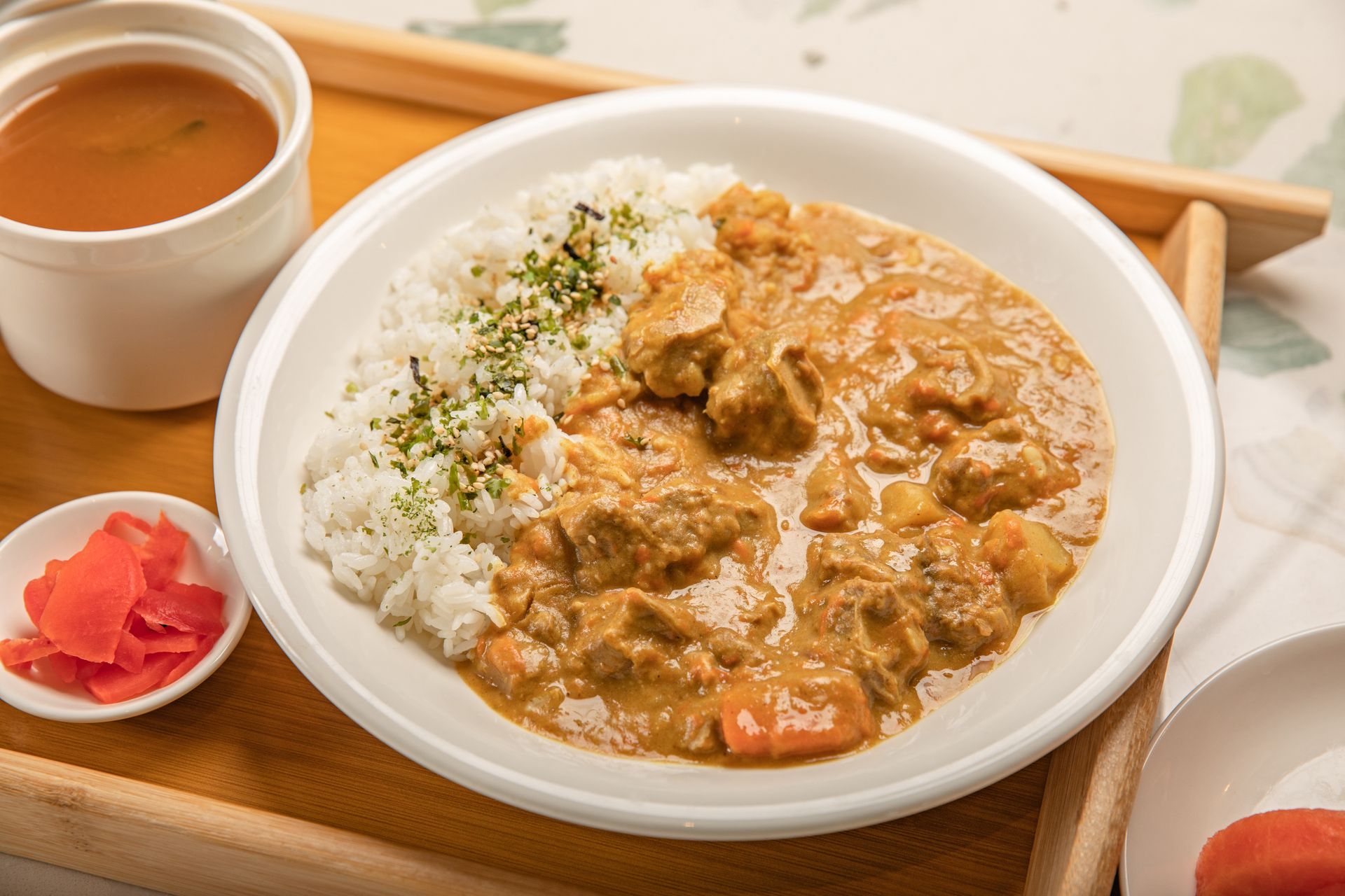 Japanese curry on a tray with soup and pickles