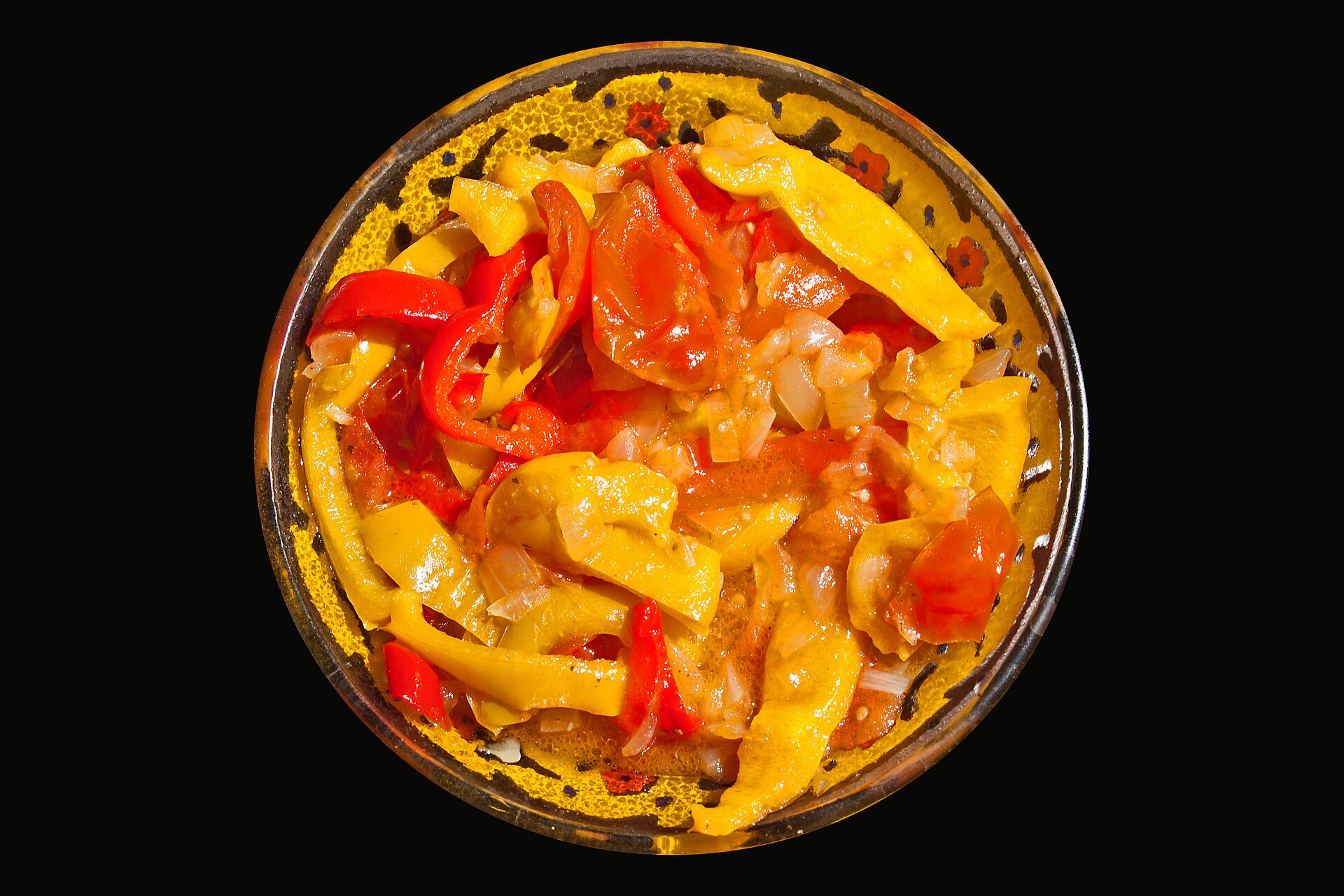Hungarian recipes: homemade lecso with sweet peppers and tomatoes in a golden bowl