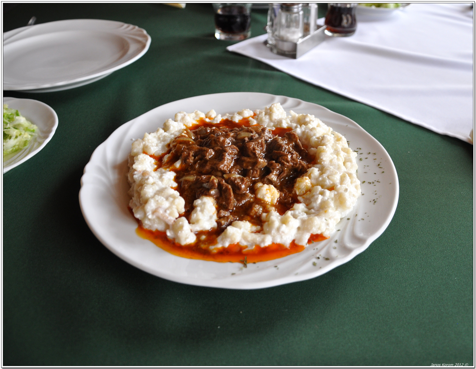 Hungarian beef porkolt stew with small dumplings on a plate