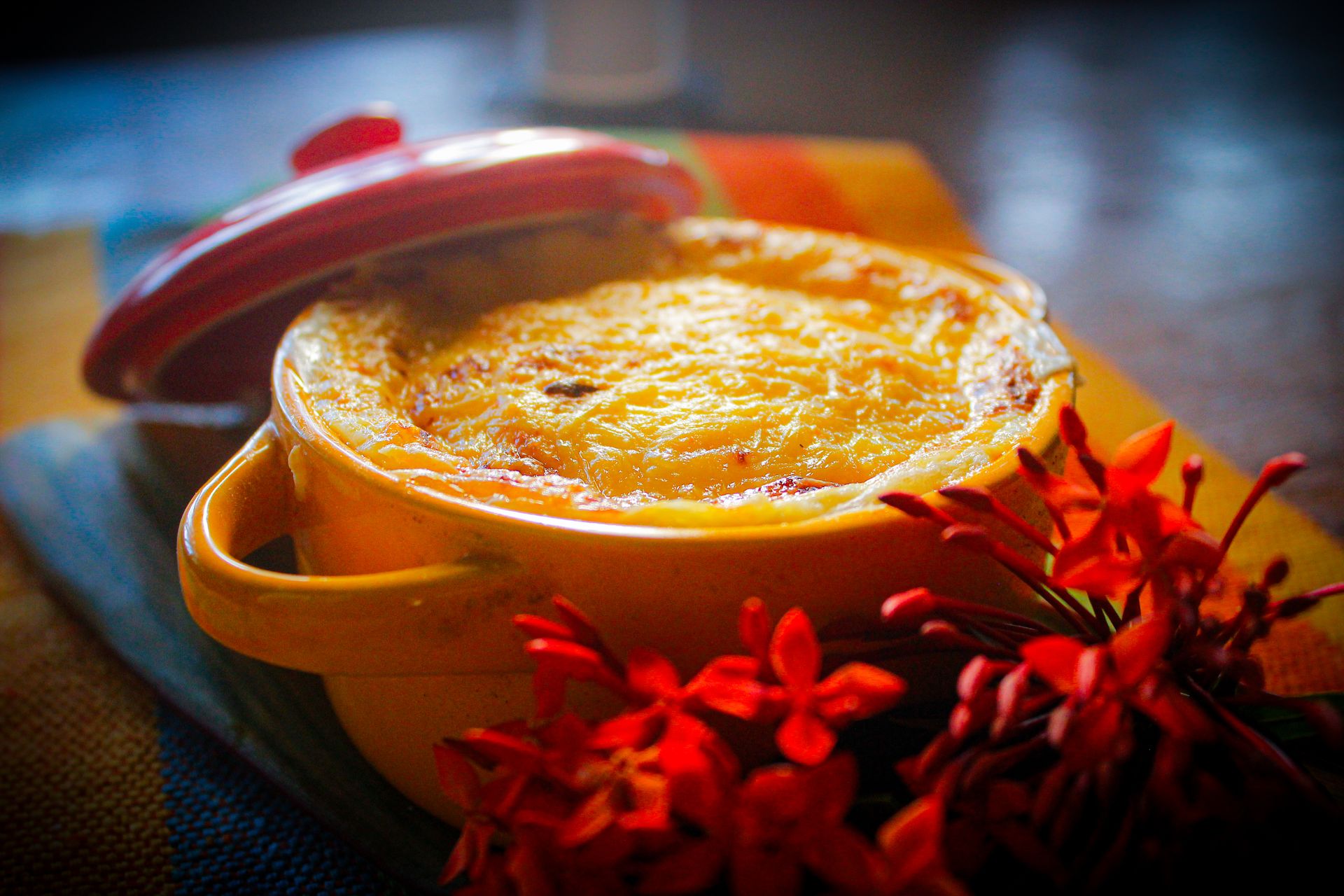 Golden baked mashed potato casserole in a red dish