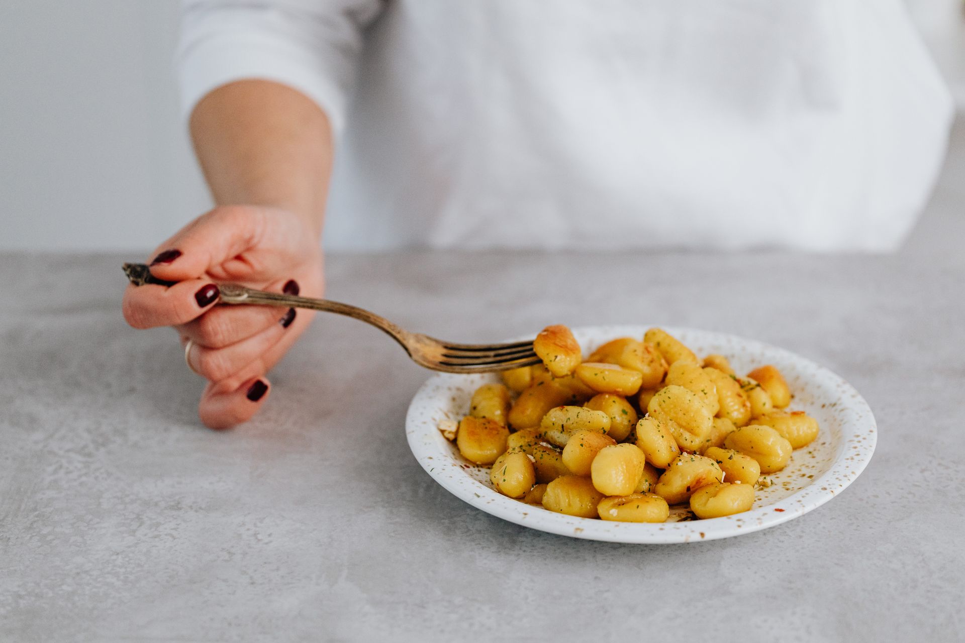 Pan fried potato gnocchi on a white plate