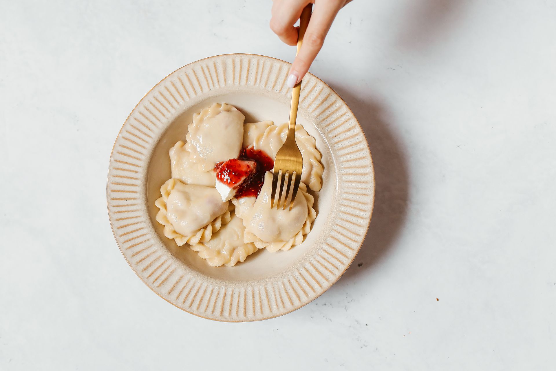 Leftover mashed potatoes: potato pierogi on a plate with a fork
