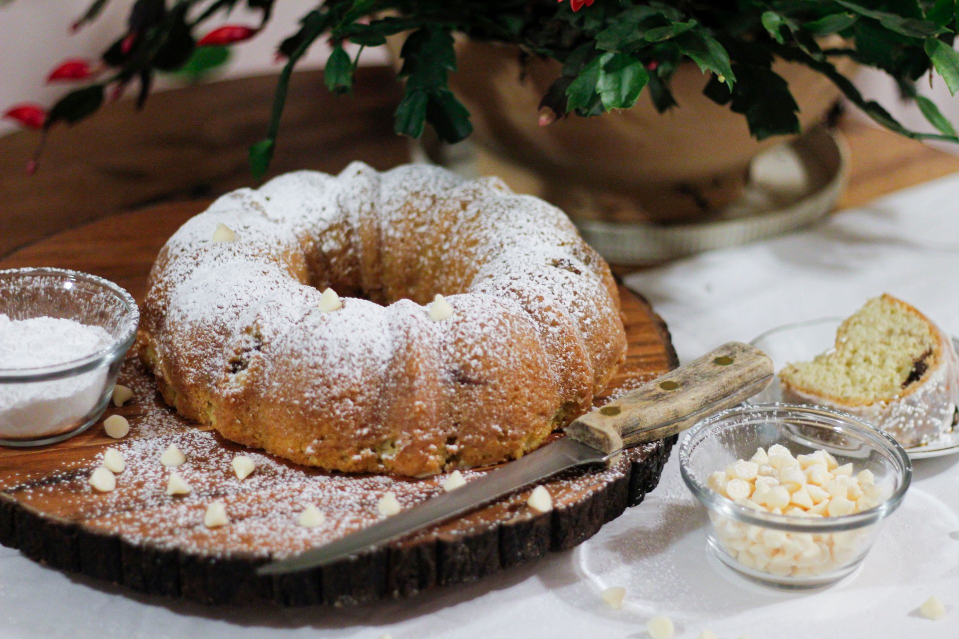 Bundt cake dusted with powdered sugar on a holiday table