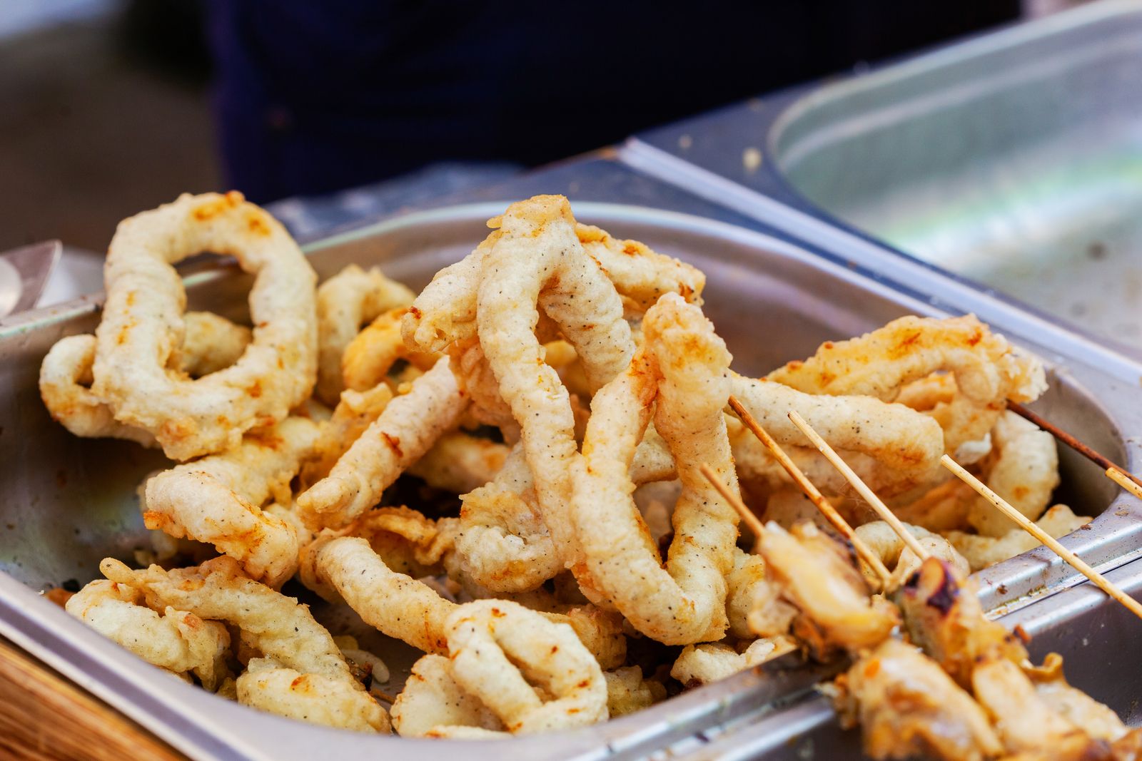 Fried calamari rings on a silver tray