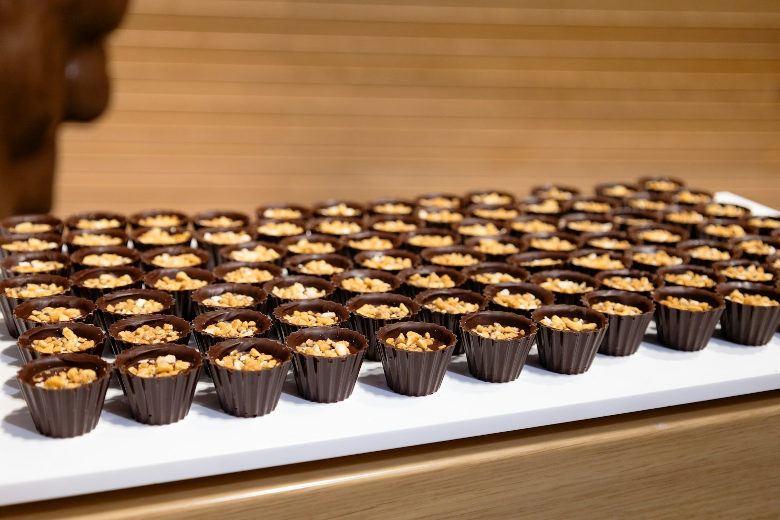 Chocolate cups filled with nuts on display, homemade Halloween candy