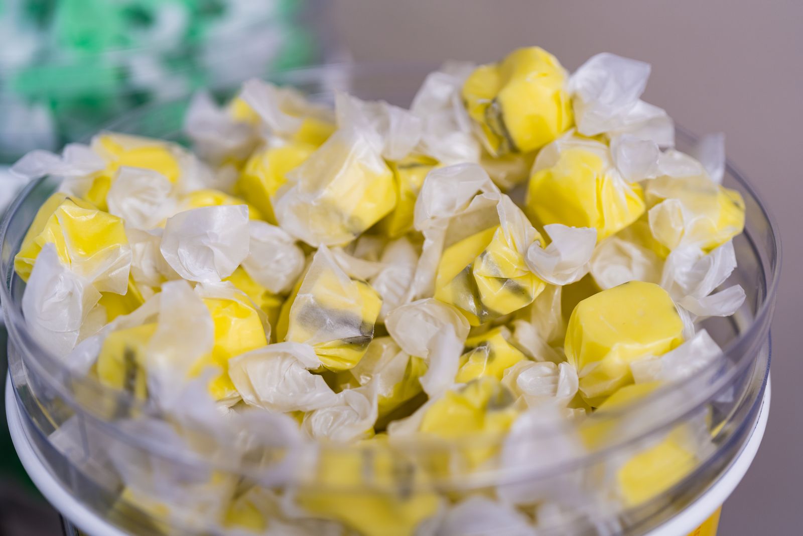Yellow wrapped taffy candies in a glass bowl