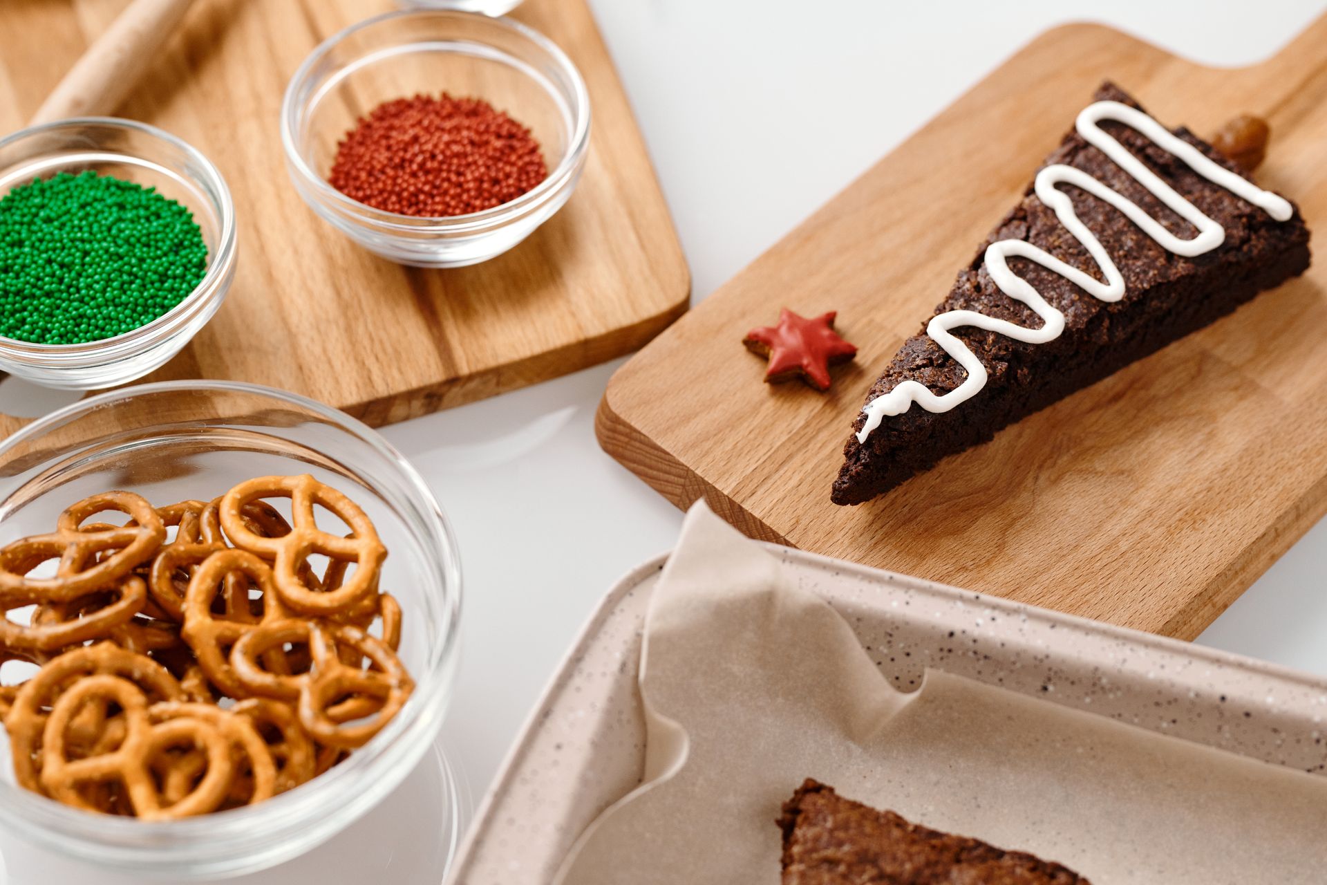 Triangle brownie Christmas tree with a white icing zigzag and a pretzel trunk