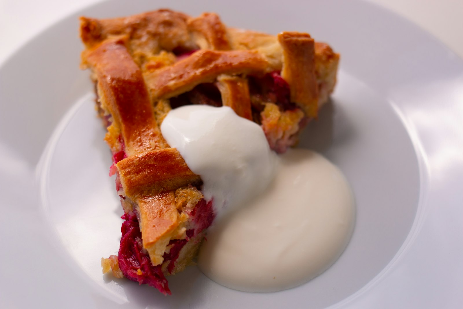 Slice of pie with a spoon of thick creme fraiche