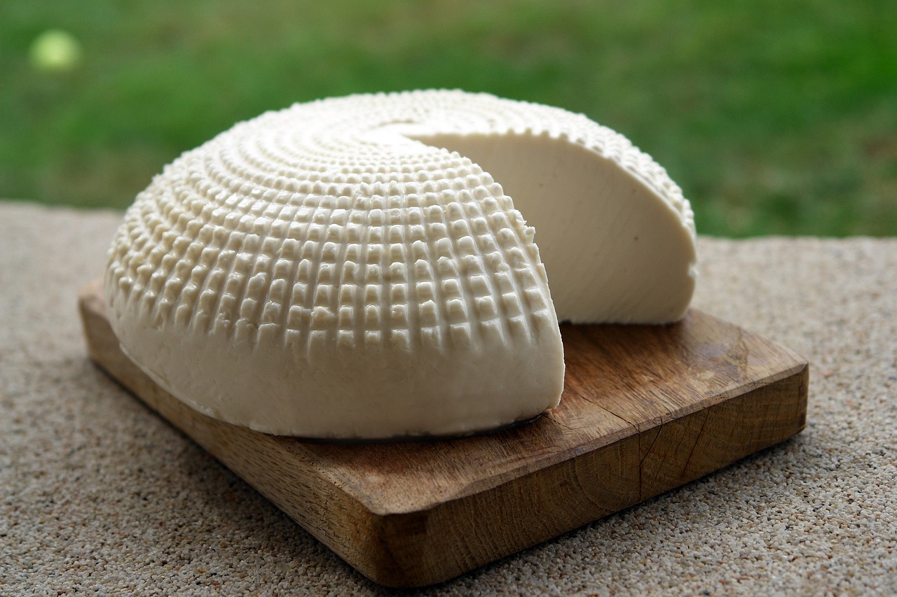 Fresh soft white cheese on a wooden board