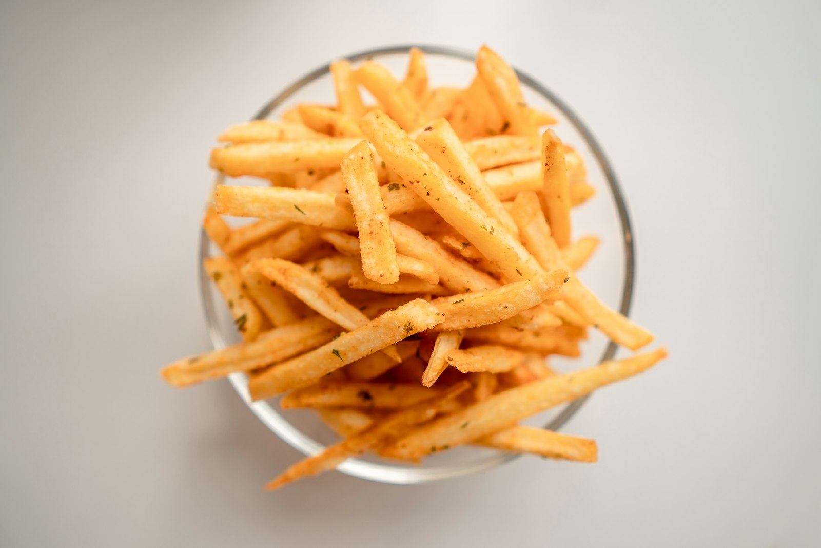Thin shoestring potato sticks on a white plate
