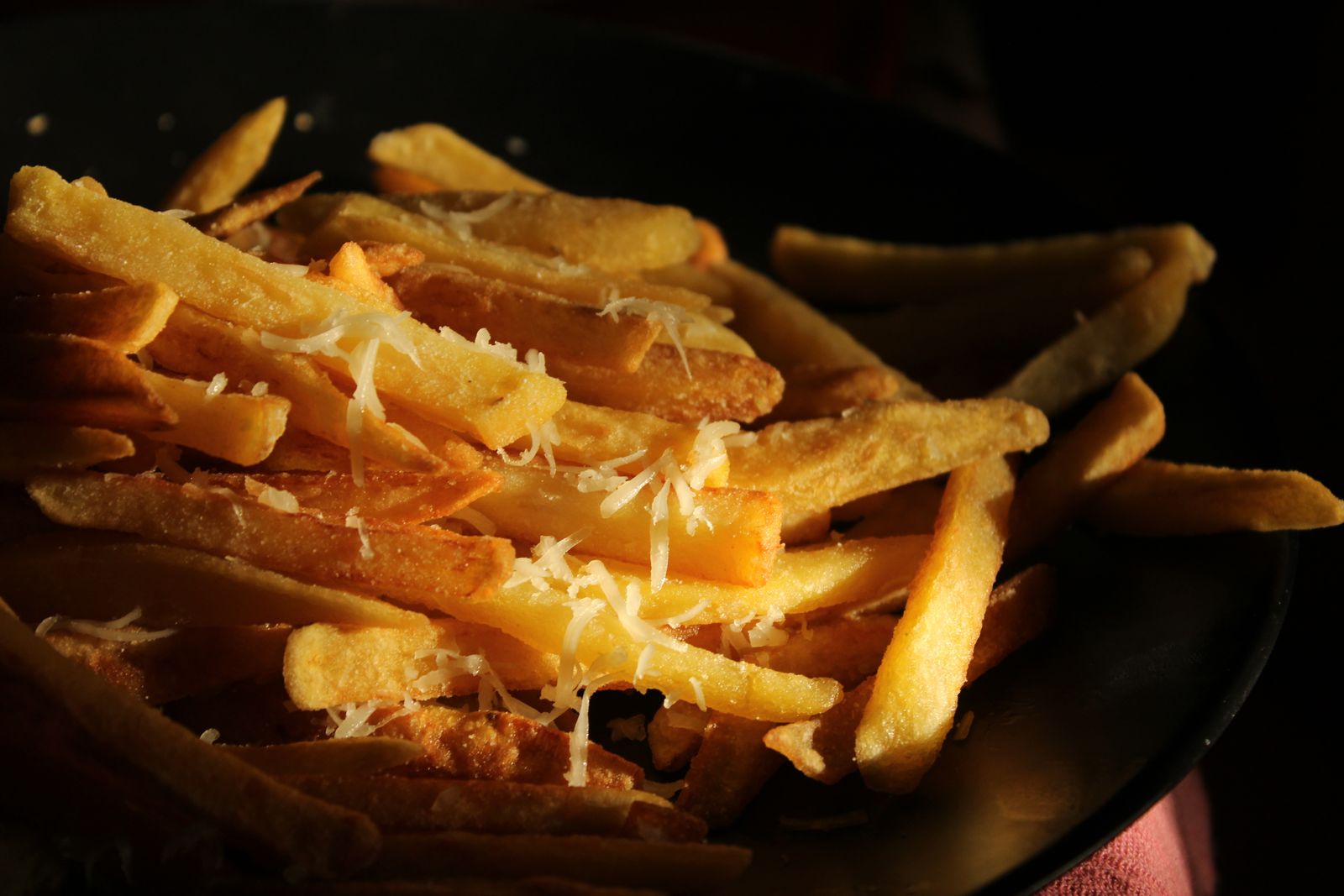 Golden potatoes covered with melted cheese sauce