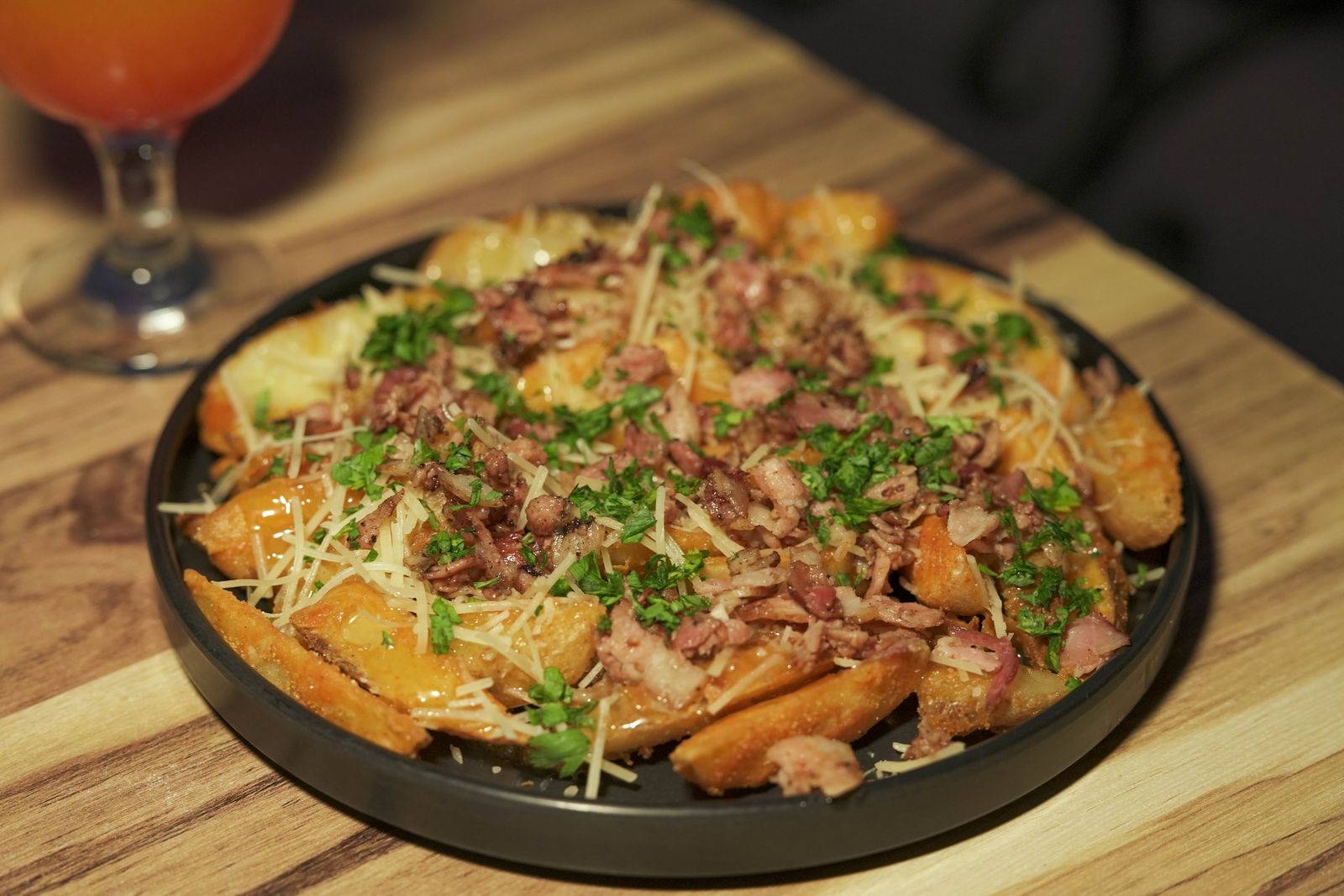 Potato wedges loaded with bacon, cheese and parsley, homemade fries