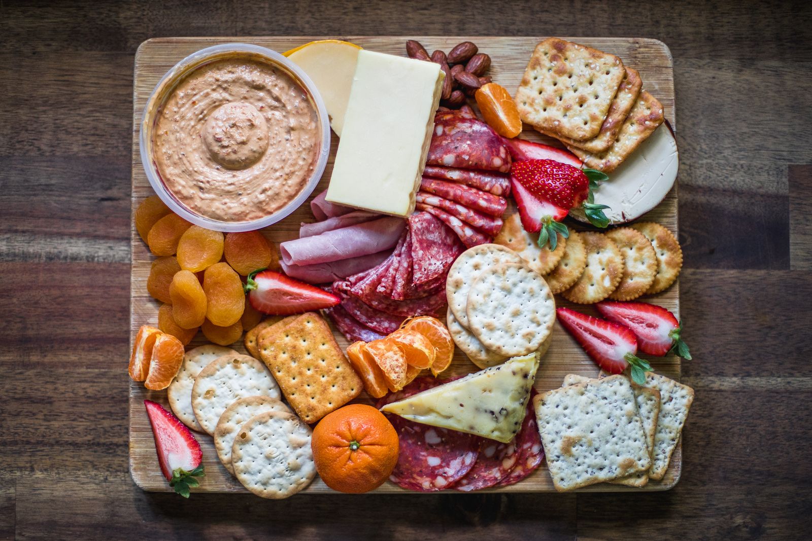 Charcuterie board with cheese, crackers, fruit and cured meats