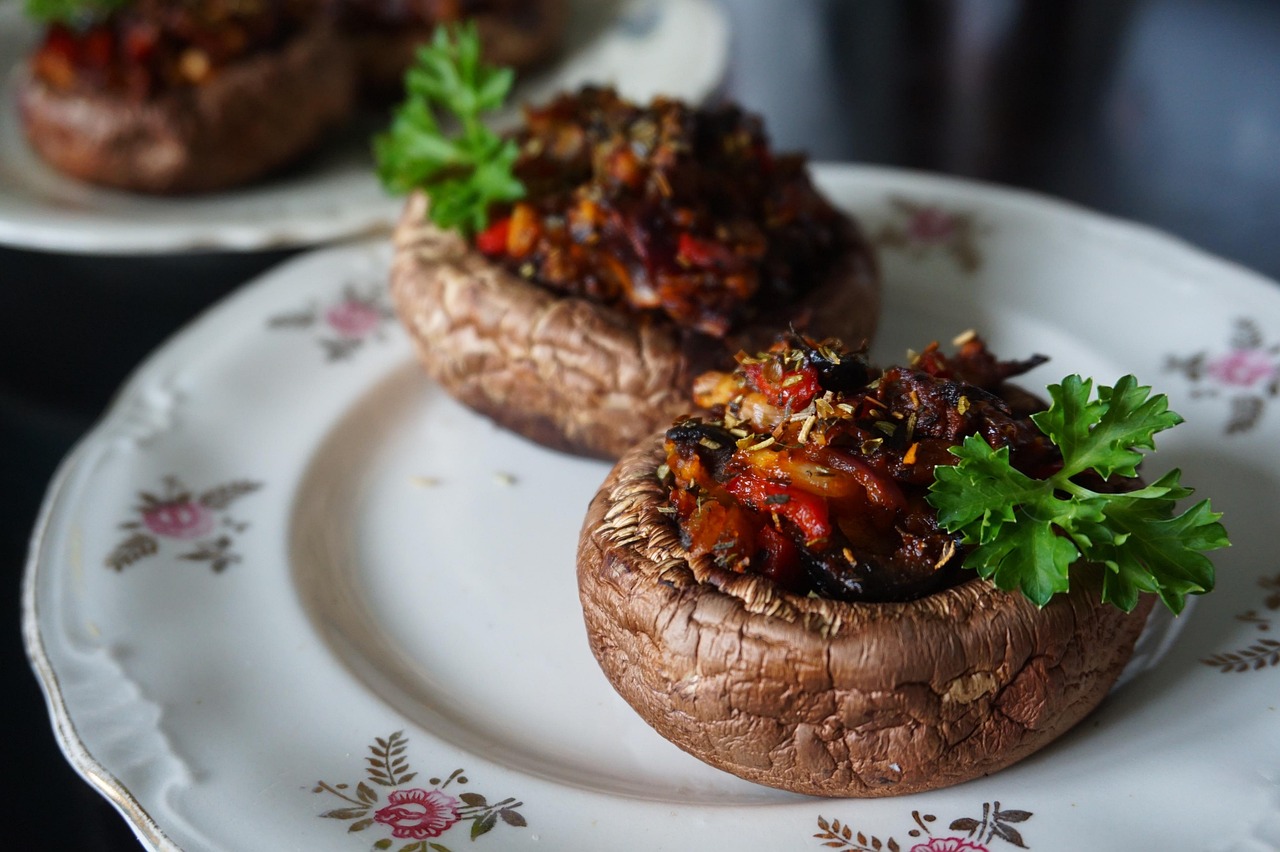 Baked stuffed mushrooms on a plate for Halloween appetizers