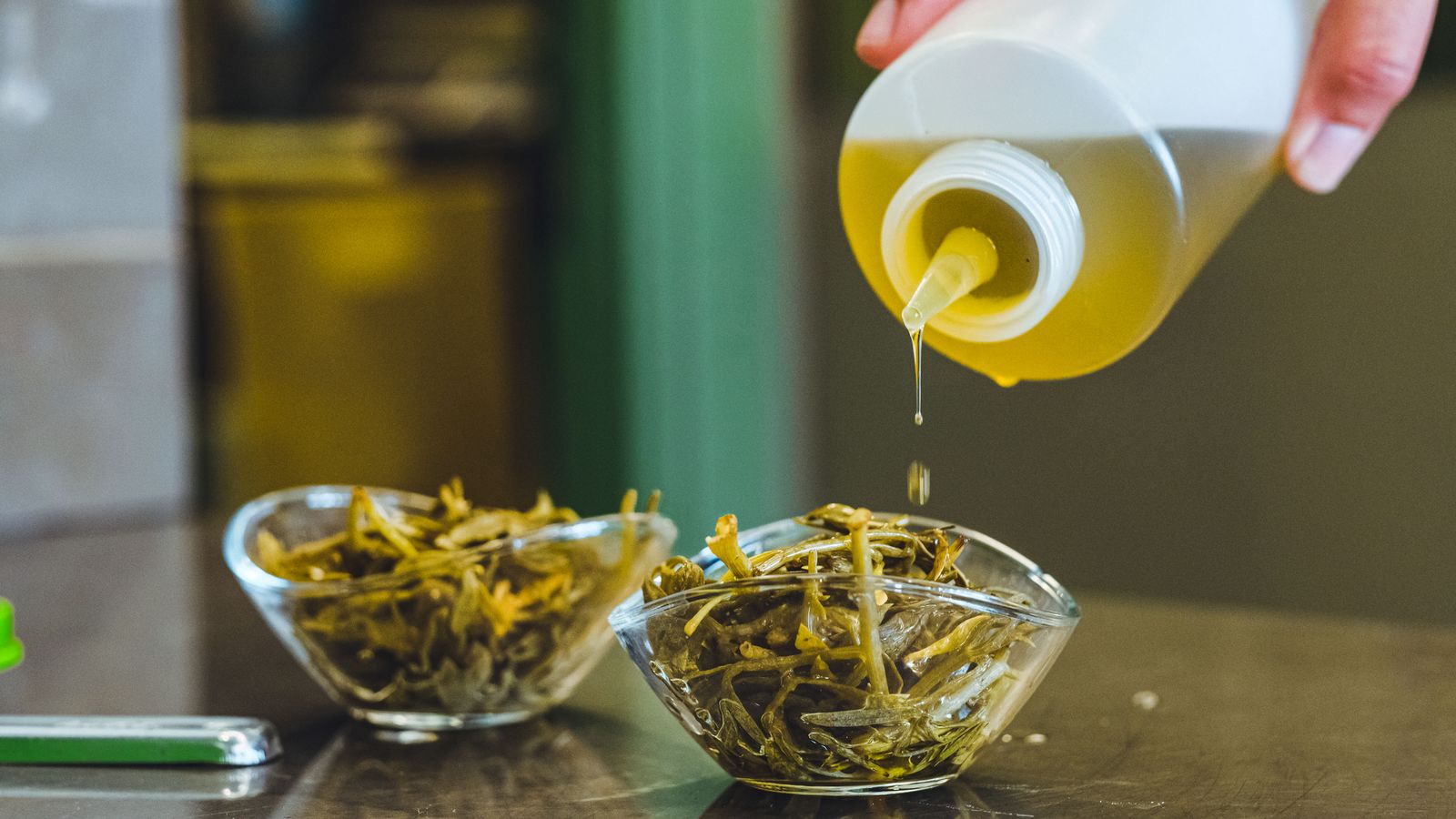Olive oil dressing poured over a fresh herb bowl, a daily Bryan Johnson habit