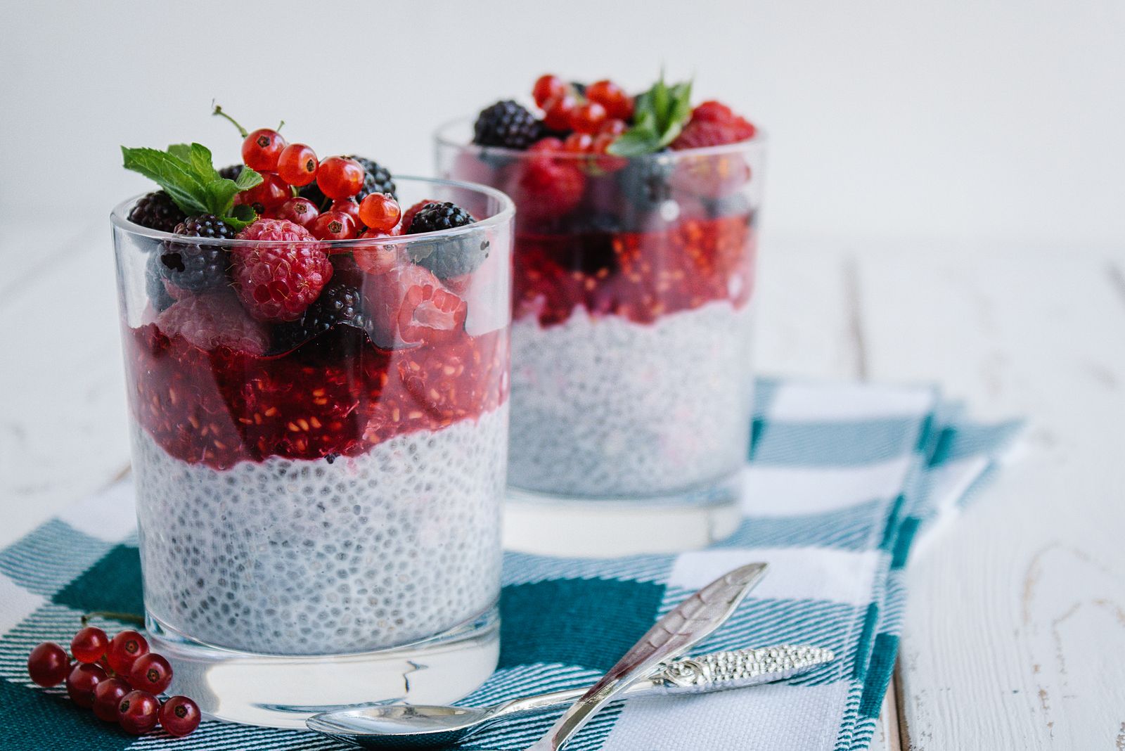 Glasses of creamy pudding layered with fresh berries