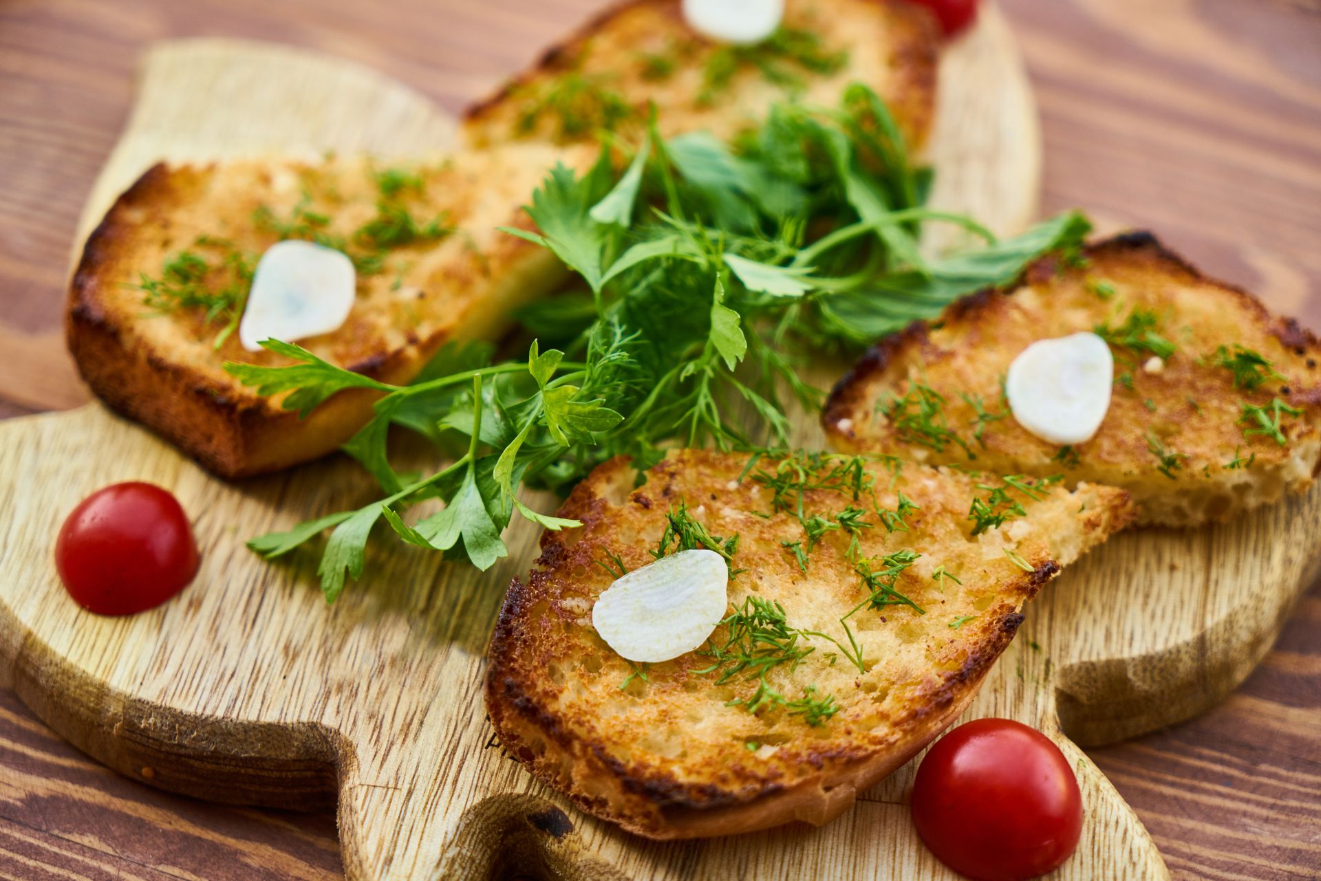 Toasted garlic bread with fresh herbs and cherry tomatoes