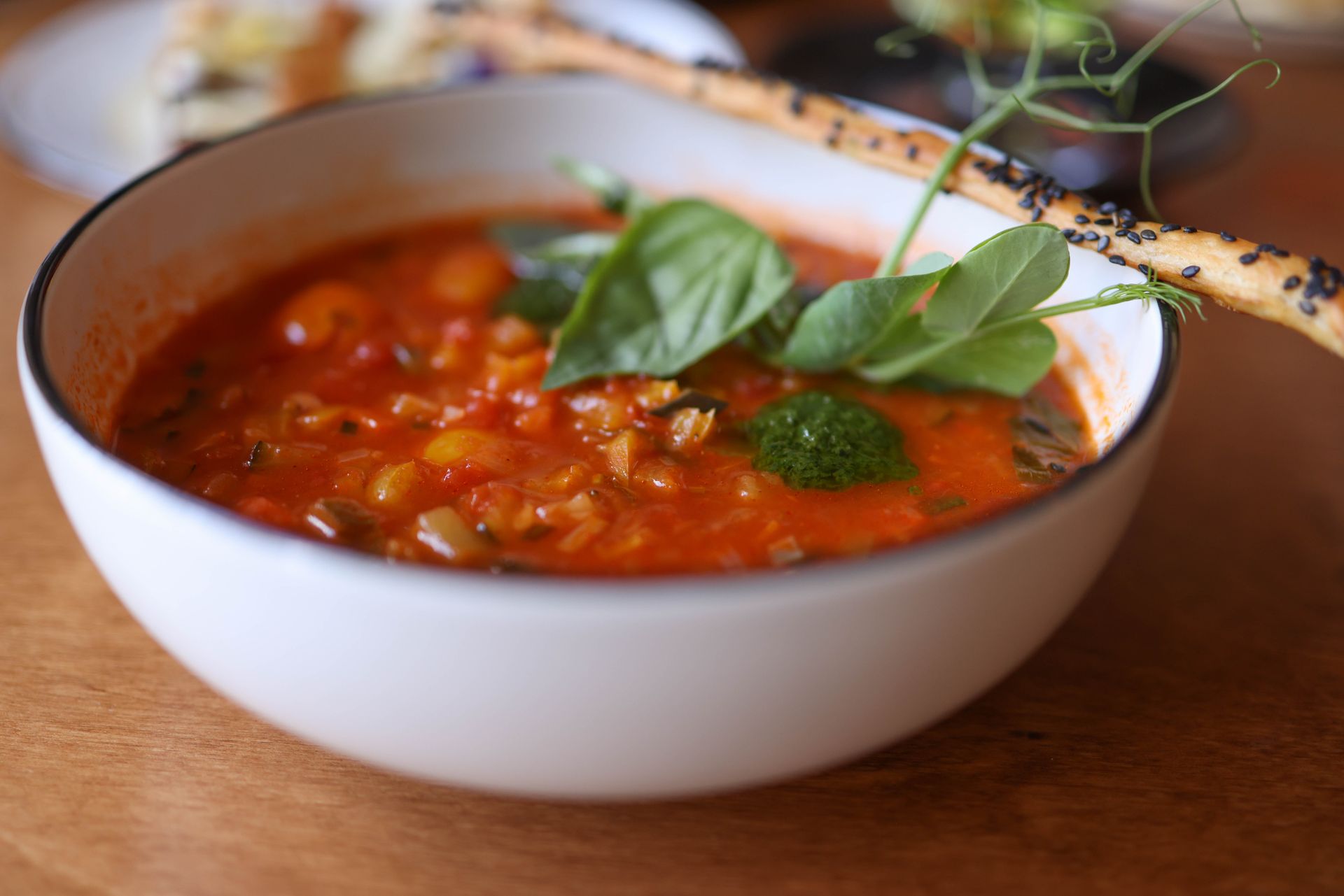 Creamy tomato bowl with fresh basil leaves