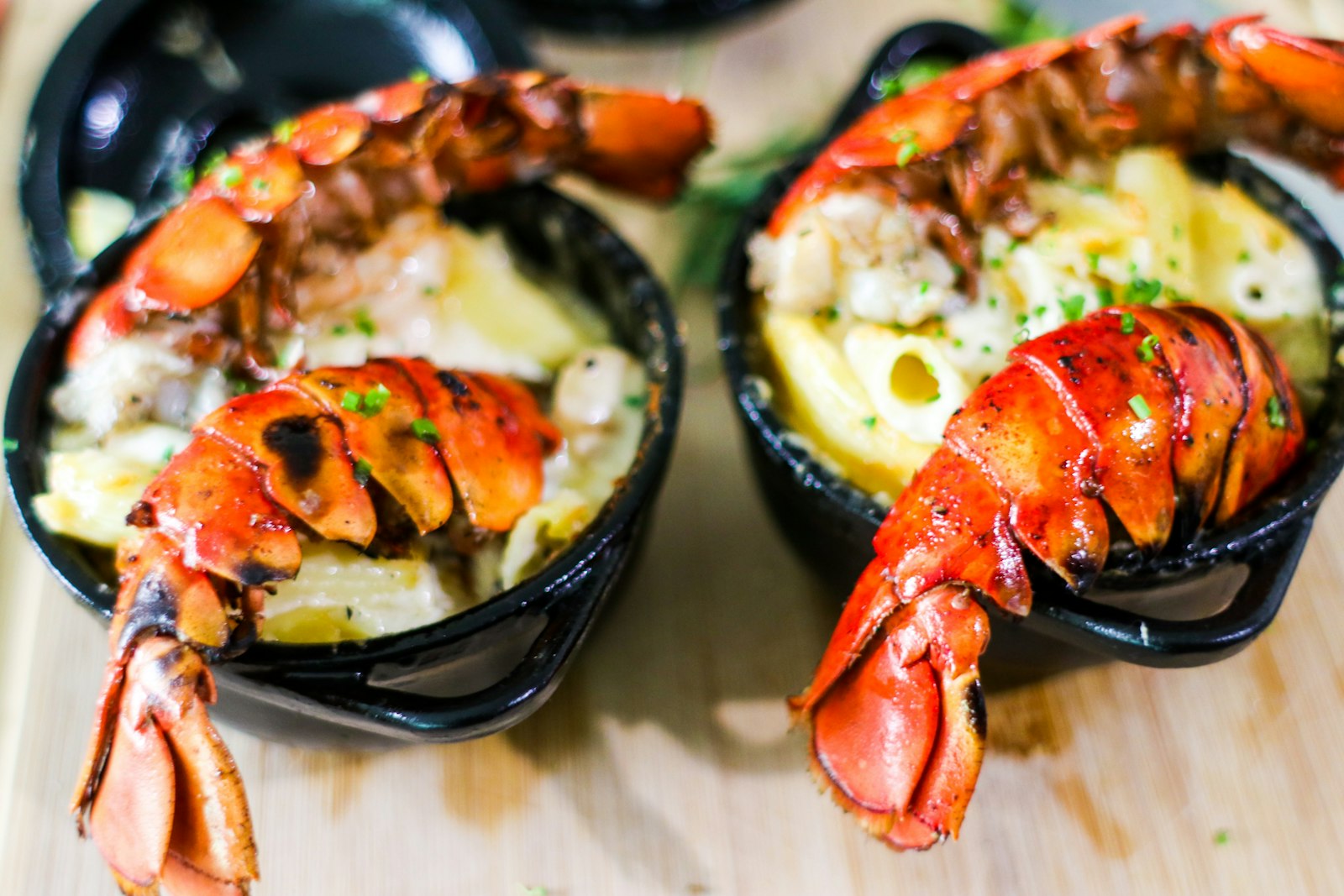 Lobster tails over creamy mac and cheese in small bowls