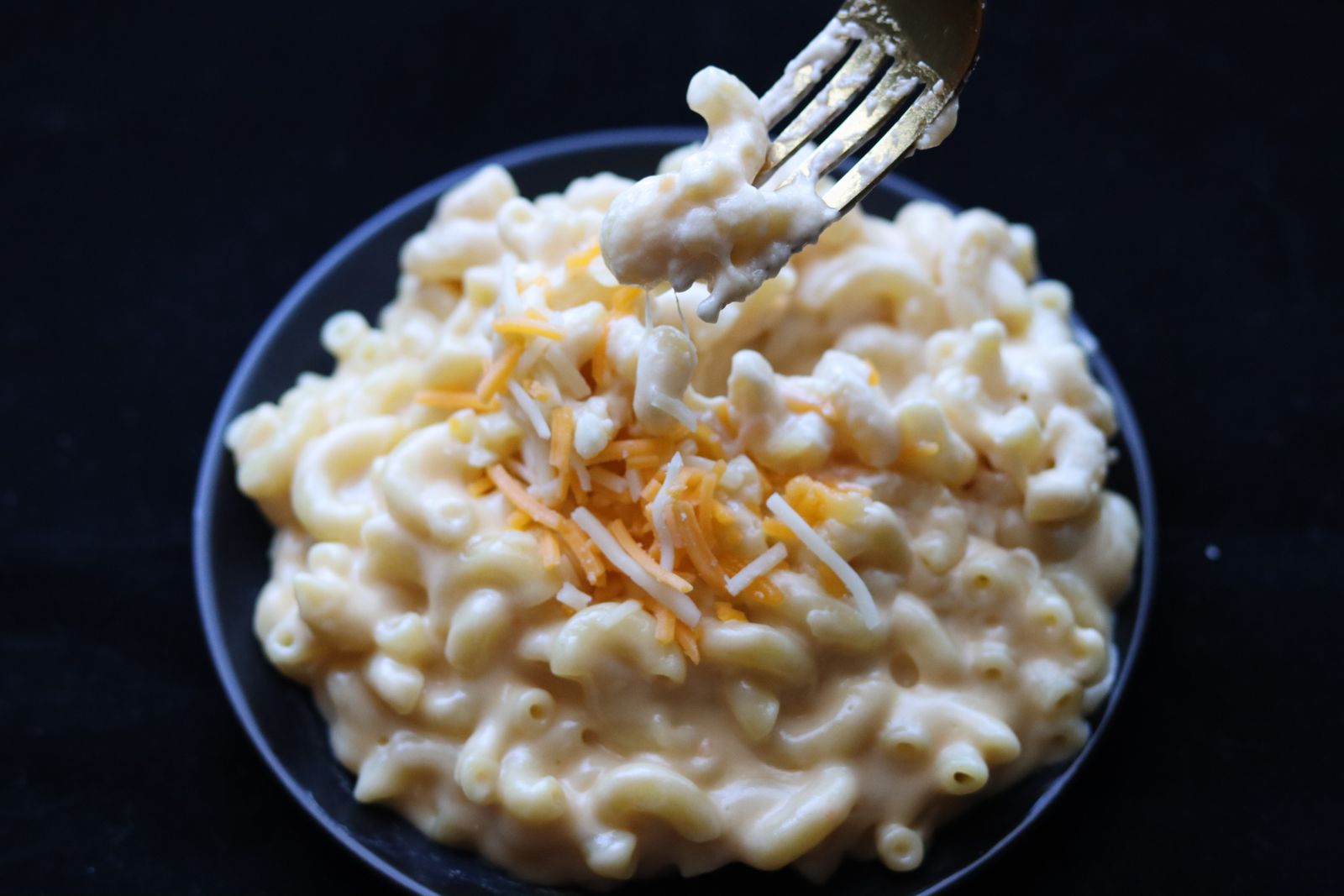 Plate of creamy stovetop elbow pasta in a cheddar sauce